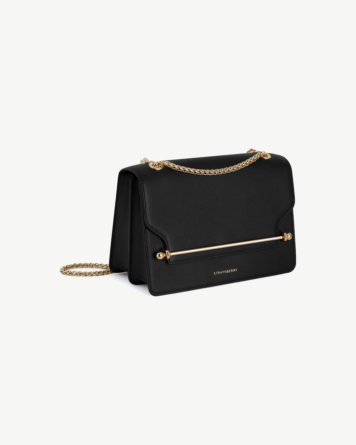 Black east-west leather bag with gold chain strap, gold bar detailing, and Strathberry logo.