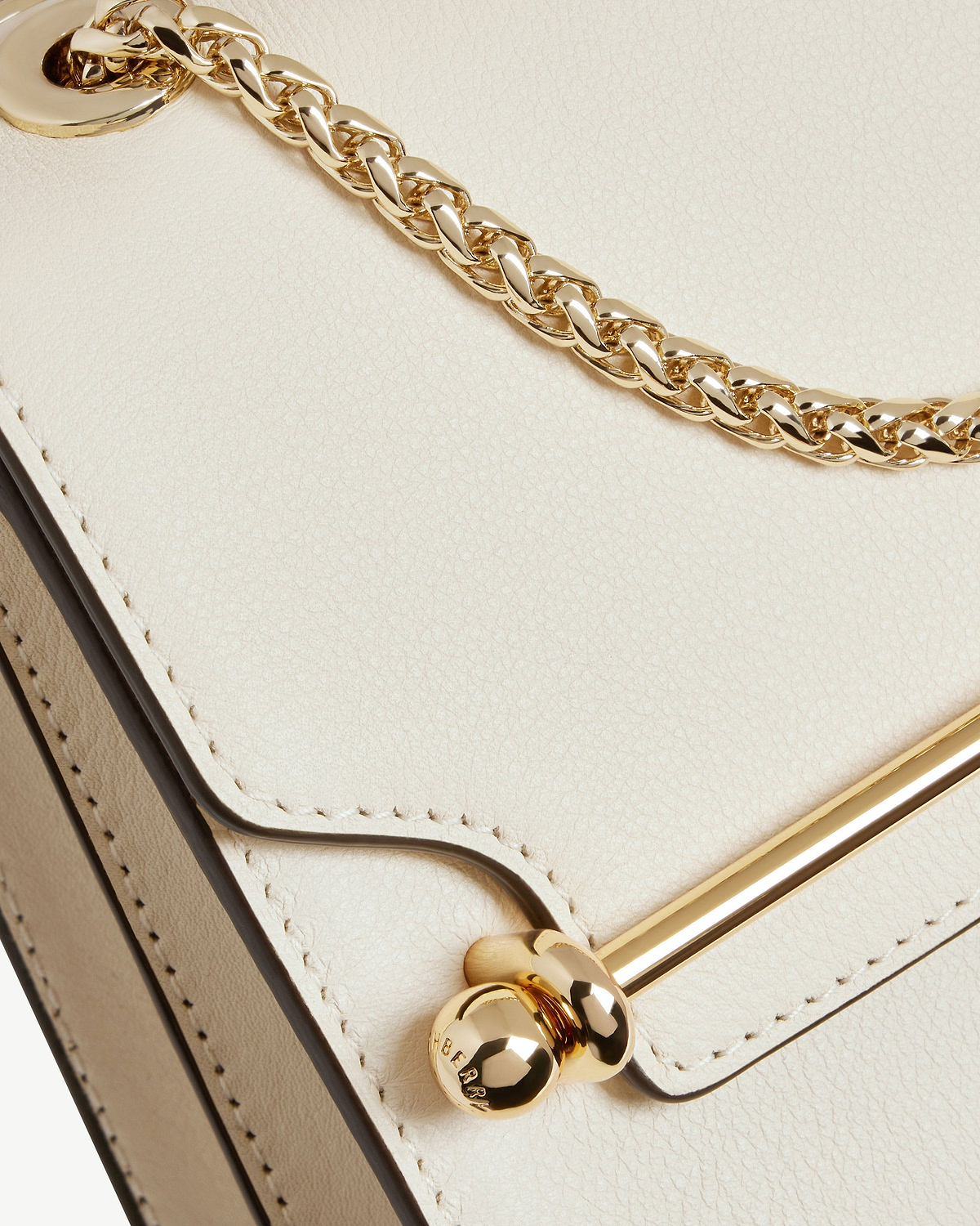 Vanilla leather East/West Mini bag showing gold chain, metal bar and stitching detail