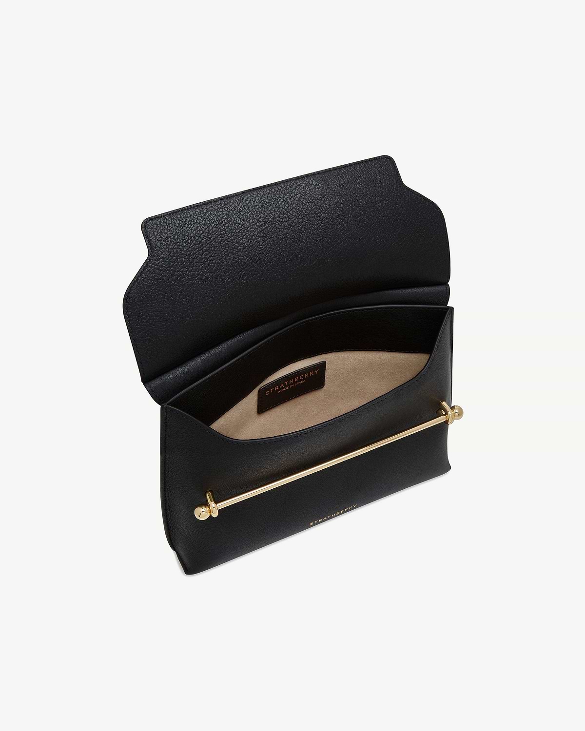 Black Stylist bag open showing beige interior, gold bar detail, Strathberry label.