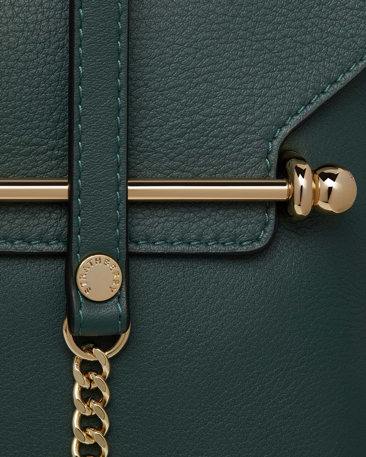 Strathberry Stylist bottle green leather bag detail showing gold hardware and chain