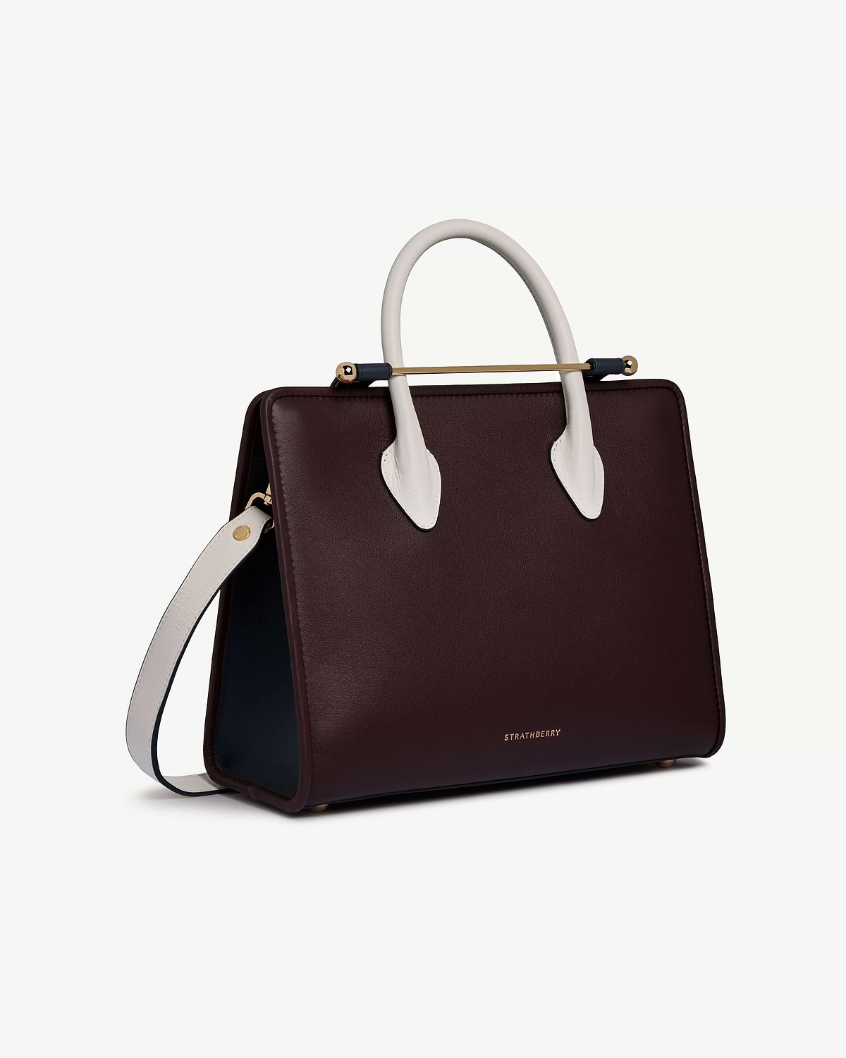 Burgundy midi tote with vanilla handles, navy sides, gold bar detail, Strathberry.