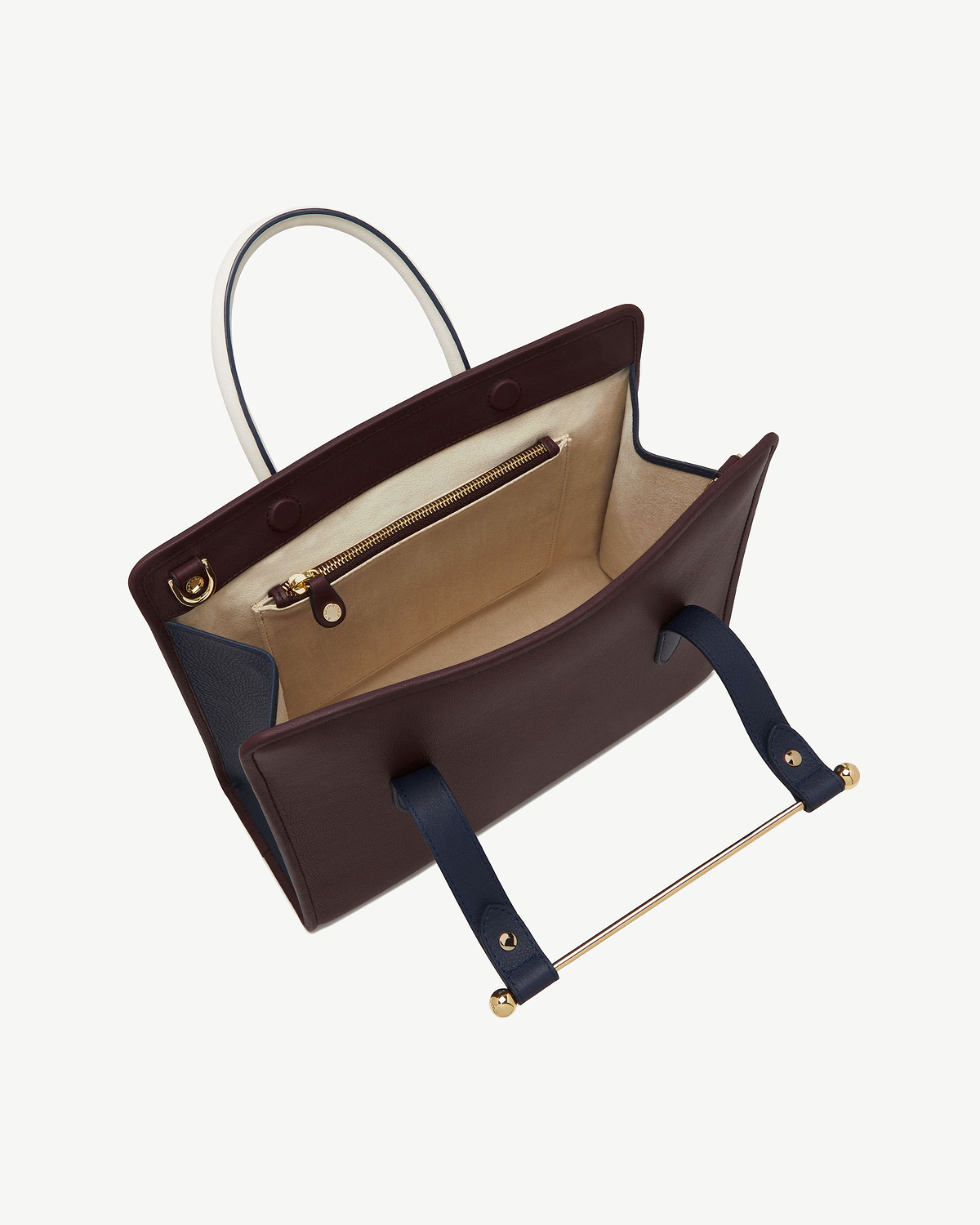 Burgundy, navy and vanilla midi tote open, showing interior pocket and gold hardware