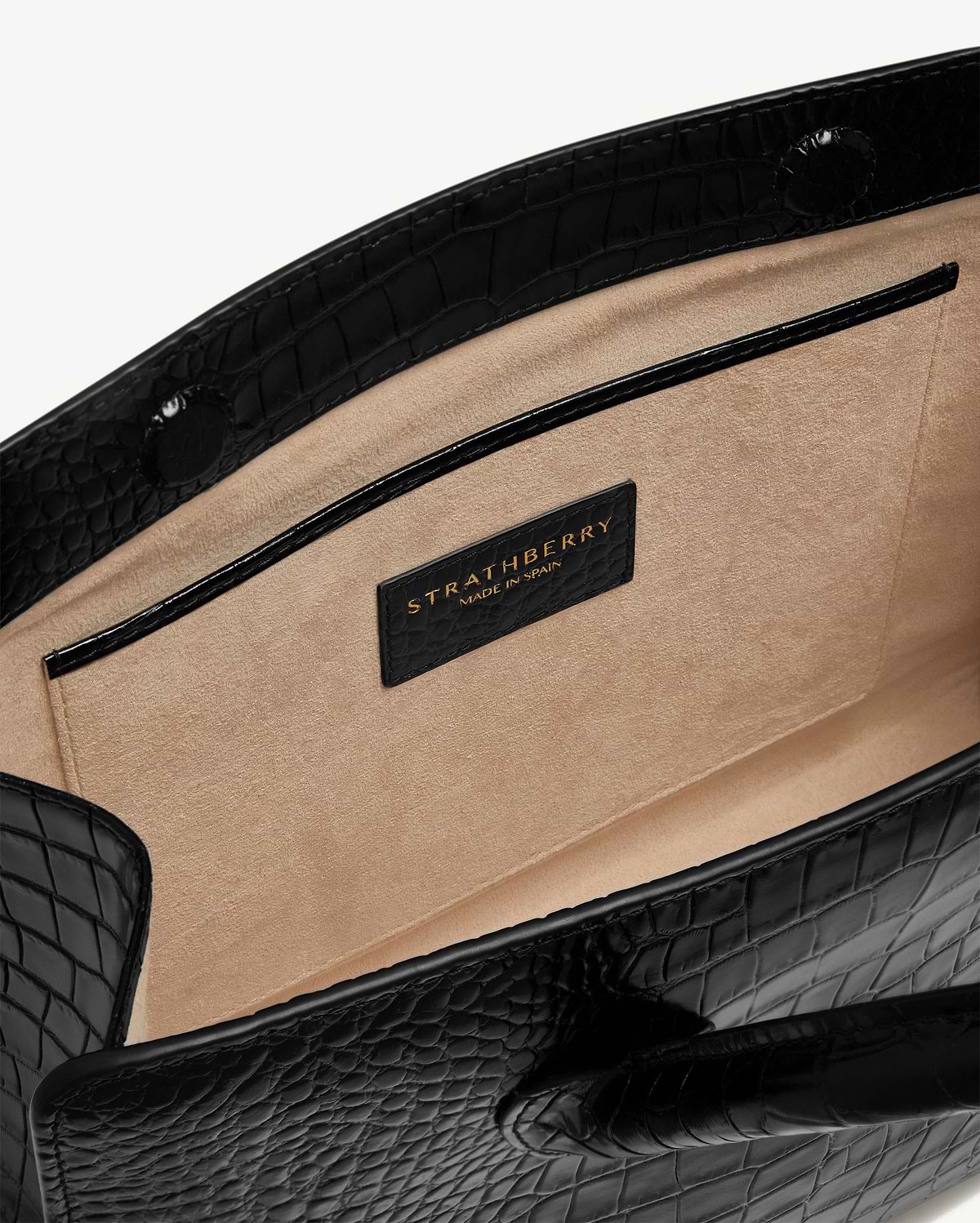 Beige suede interior and pocket of black croc-embossed Strathberry midi tote.