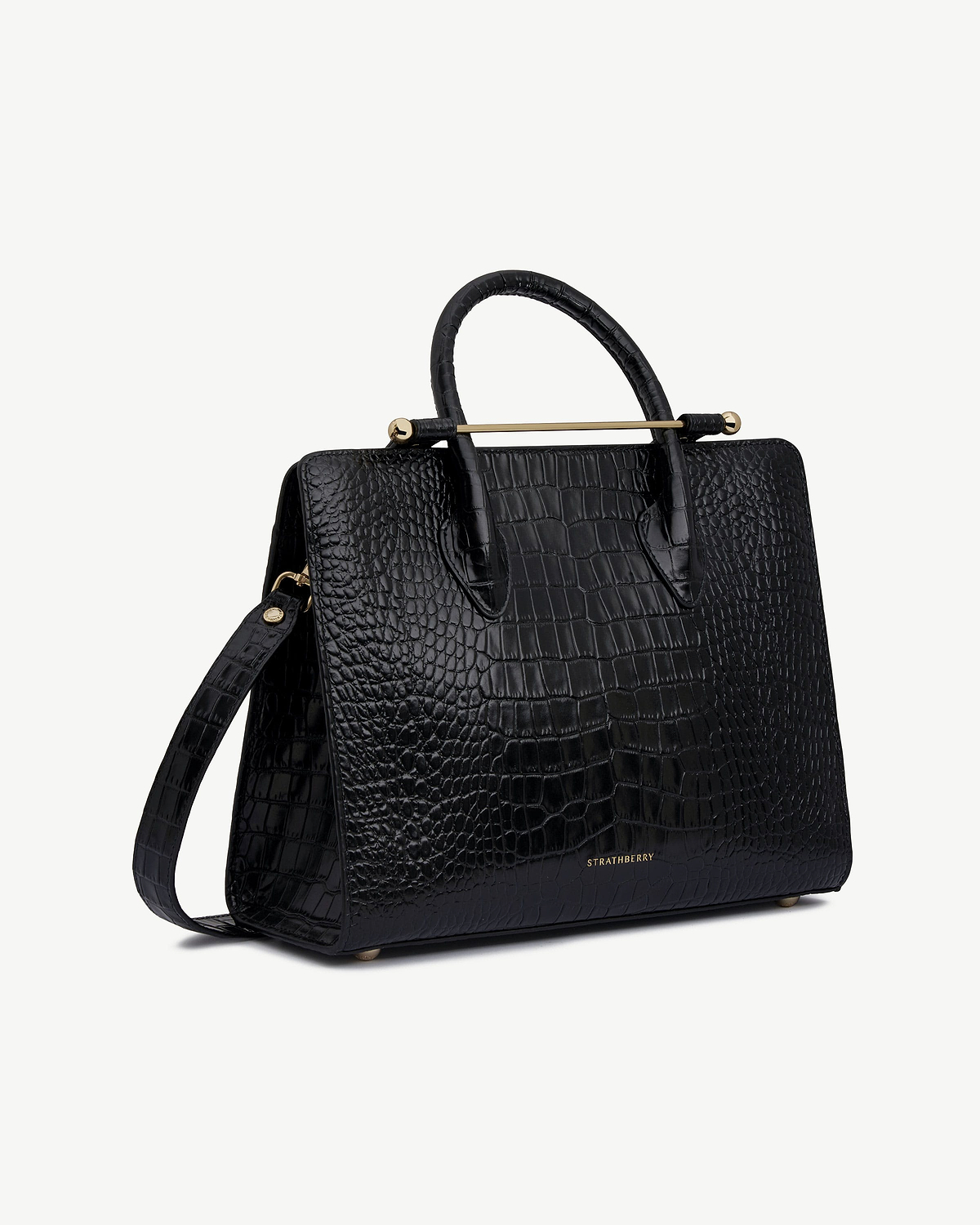 Strathberry black croc midi tote with top handles, shoulder strap, gold bar.