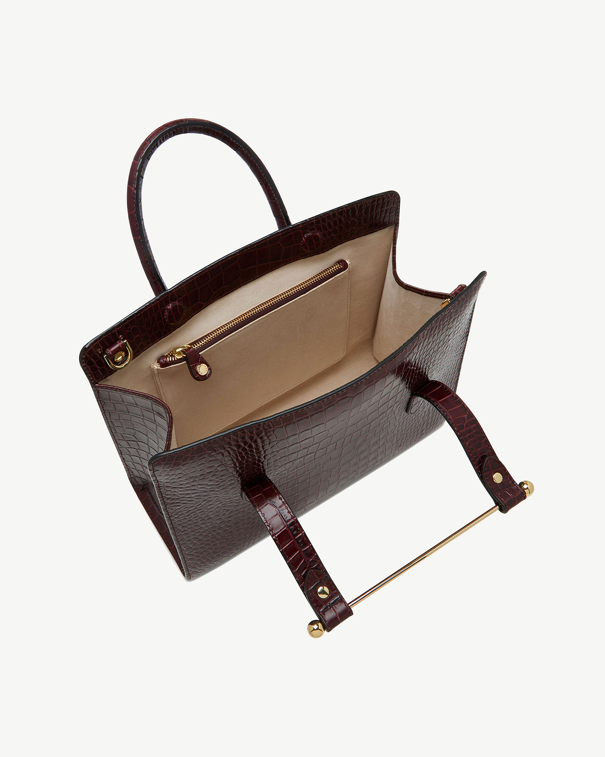 Open croc-embossed midi tote with beige interior, gold zip pocket and gold bar handle.