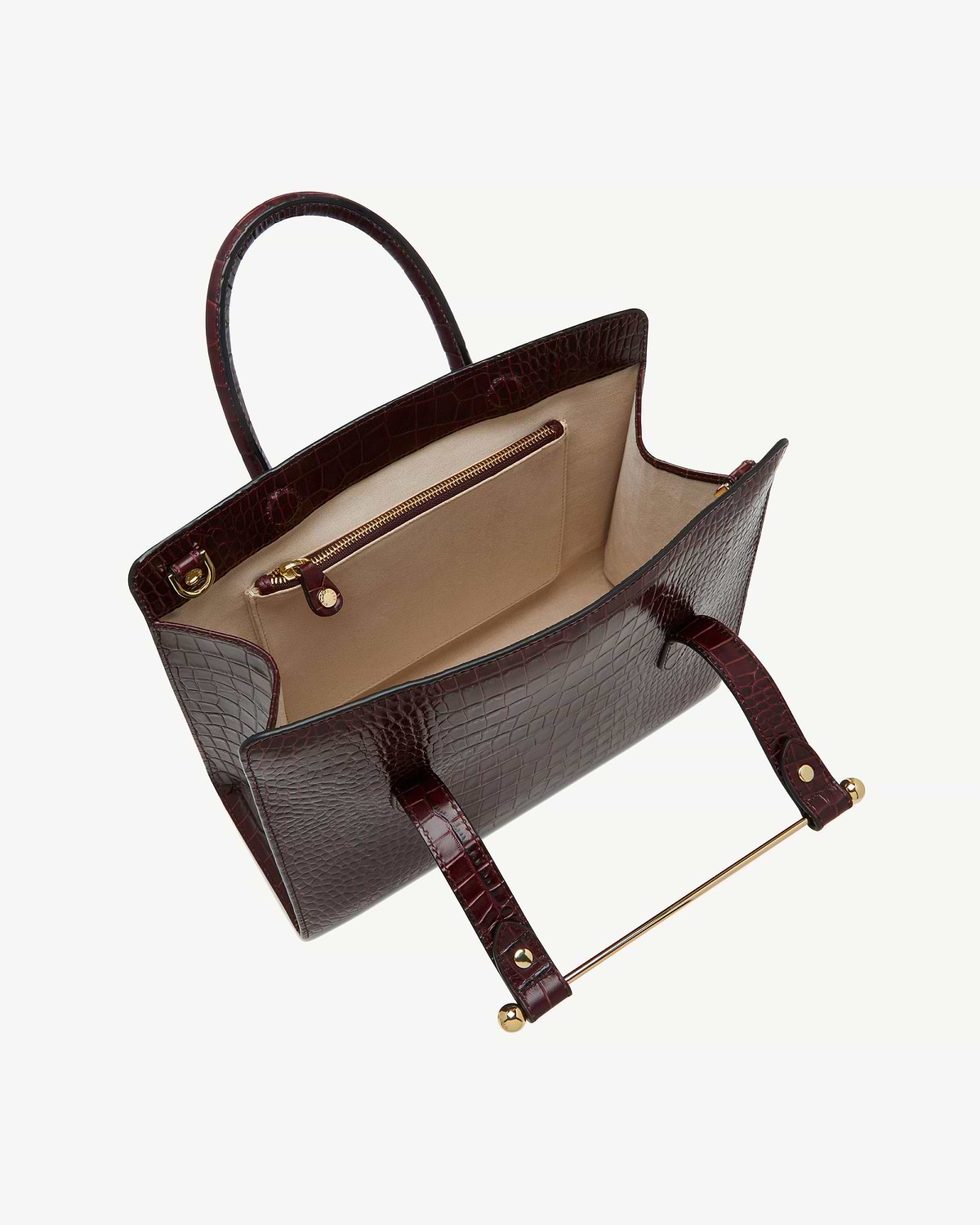 Open croc-embossed midi tote with beige interior, gold zip pocket and gold bar handle.