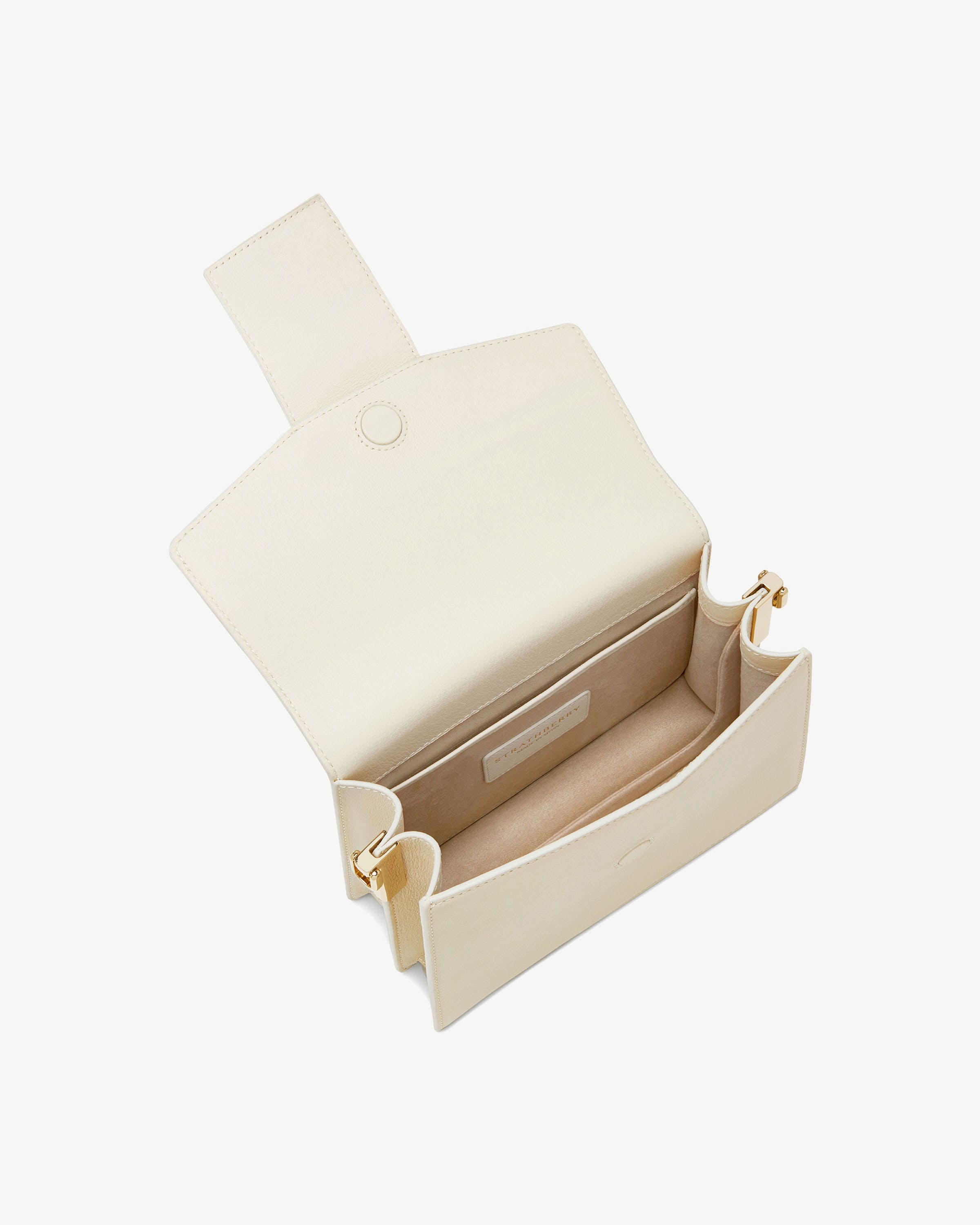 Vanilla Box Crescent bag open showing interior pocket and gold-tone hardware.