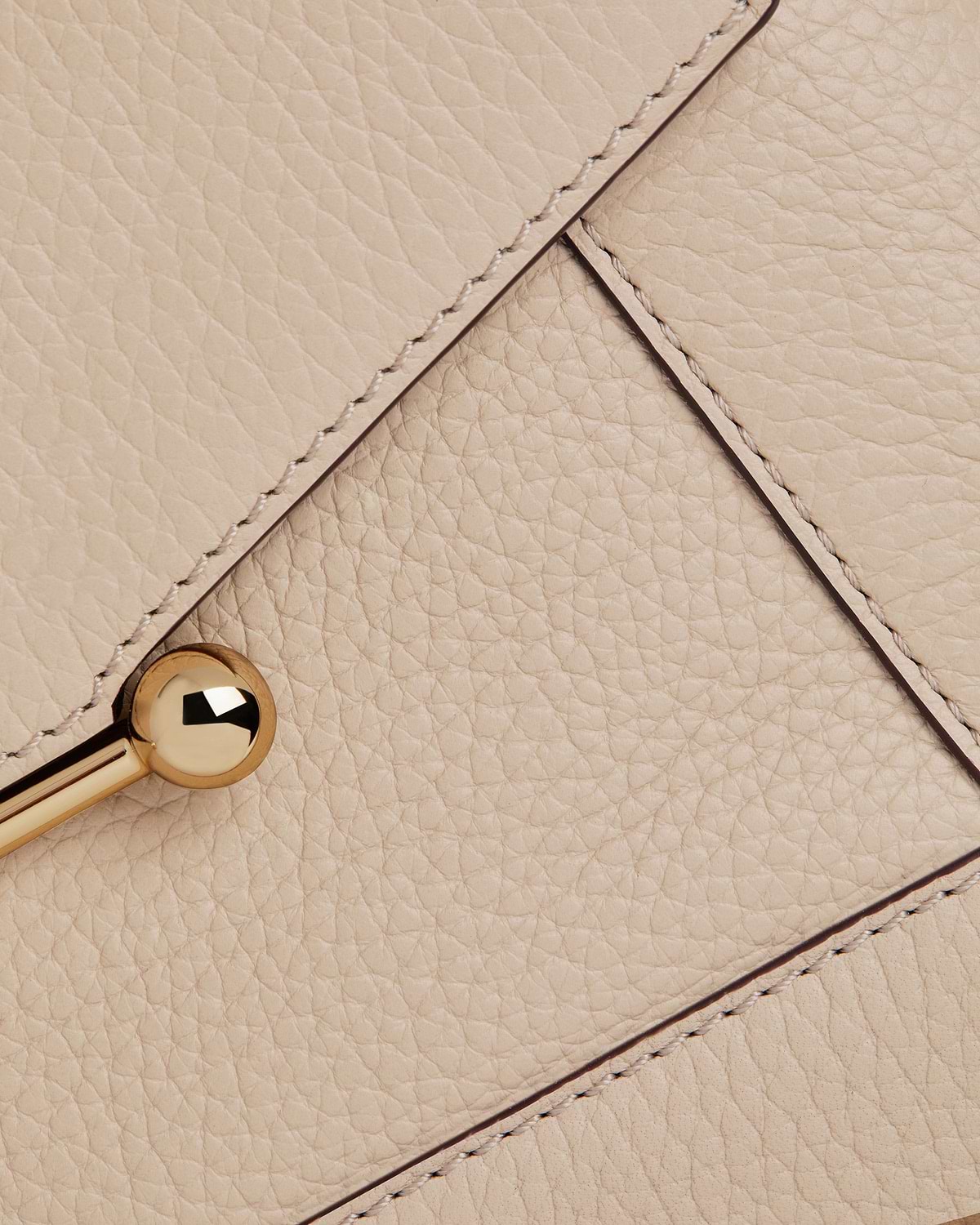 Oat-coloured pebbled leather mosaic bag panel with stitched seams and gold ball clasp.