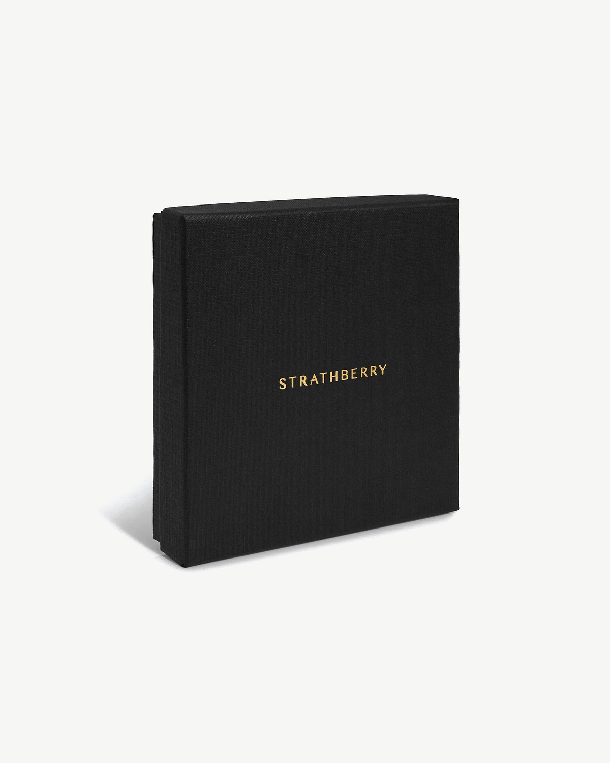 Black Strathberry box with gold logo, placed at an angle on a white background.