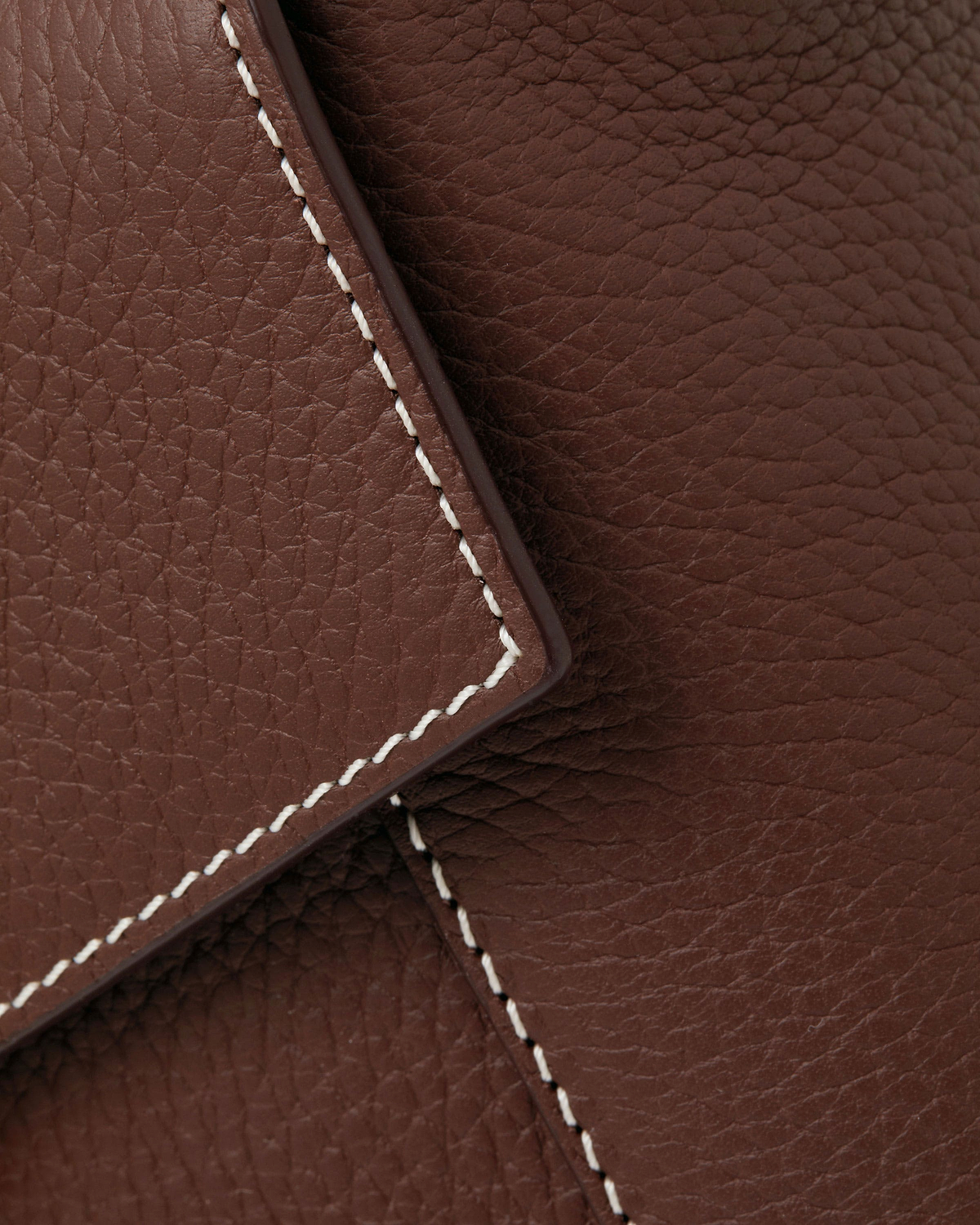 Chocolate pebbled leather with vanilla stitching along a mosaic bag flap.