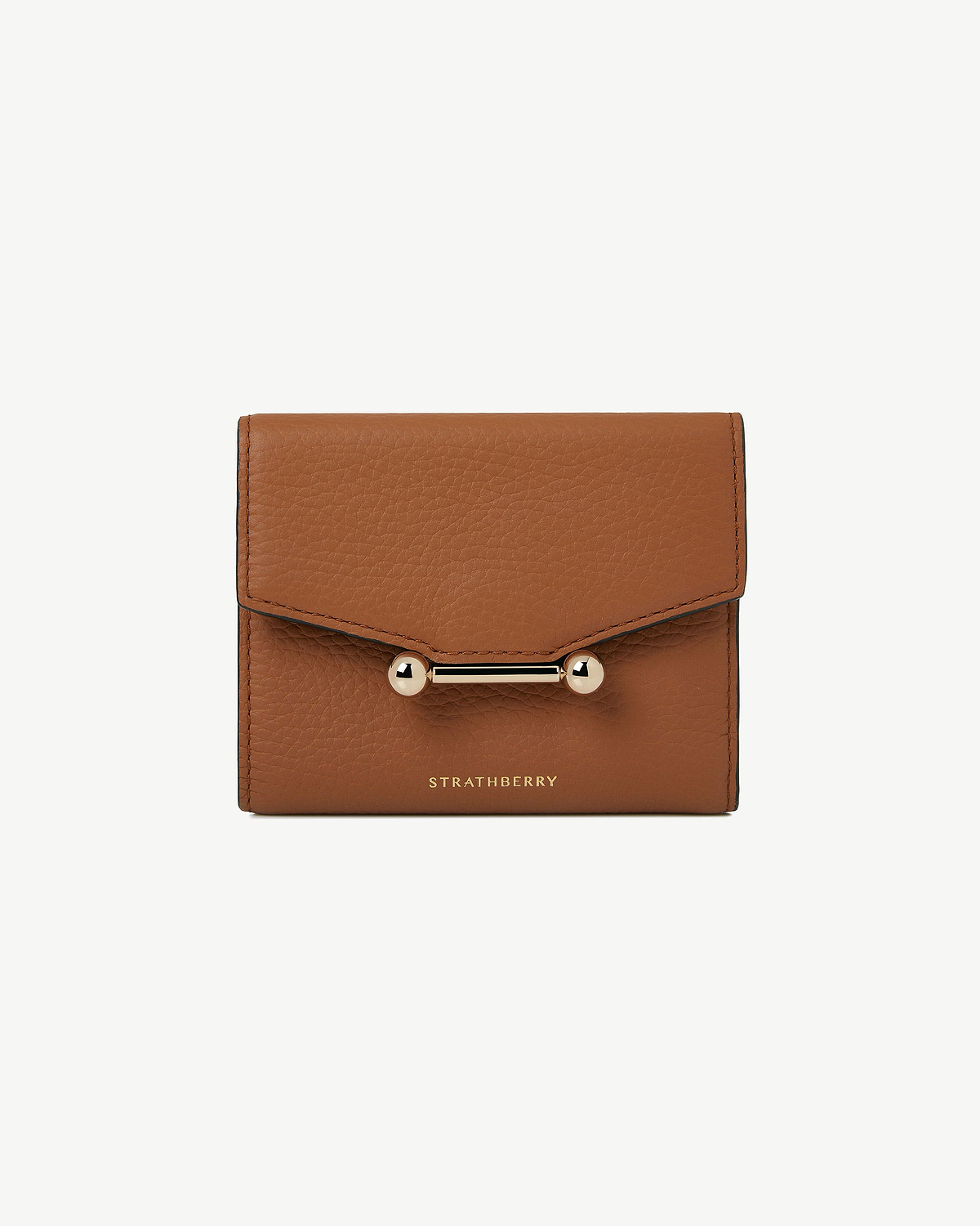 Tan trifold wallet in pebbled leather with gold bar clasp and Strathberry logo