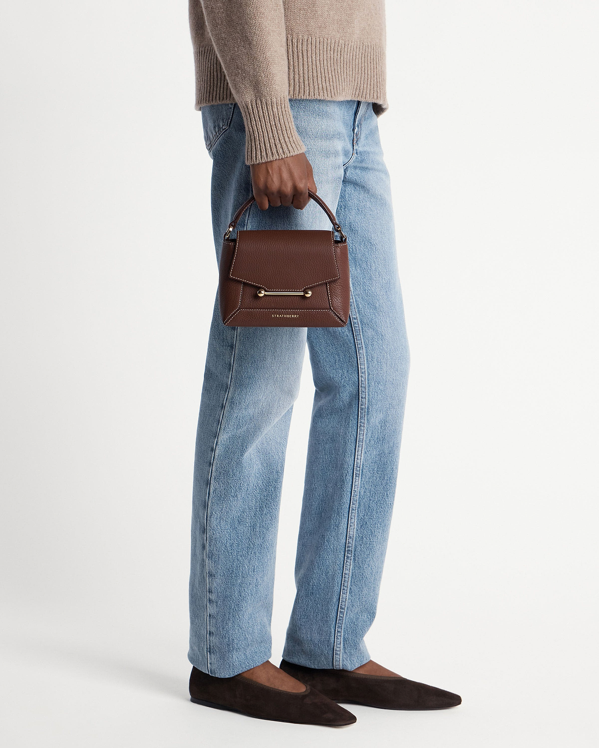 Strathberry Mosaic Nano chocolate leather top-handle bag with vanilla stitching, handheld.