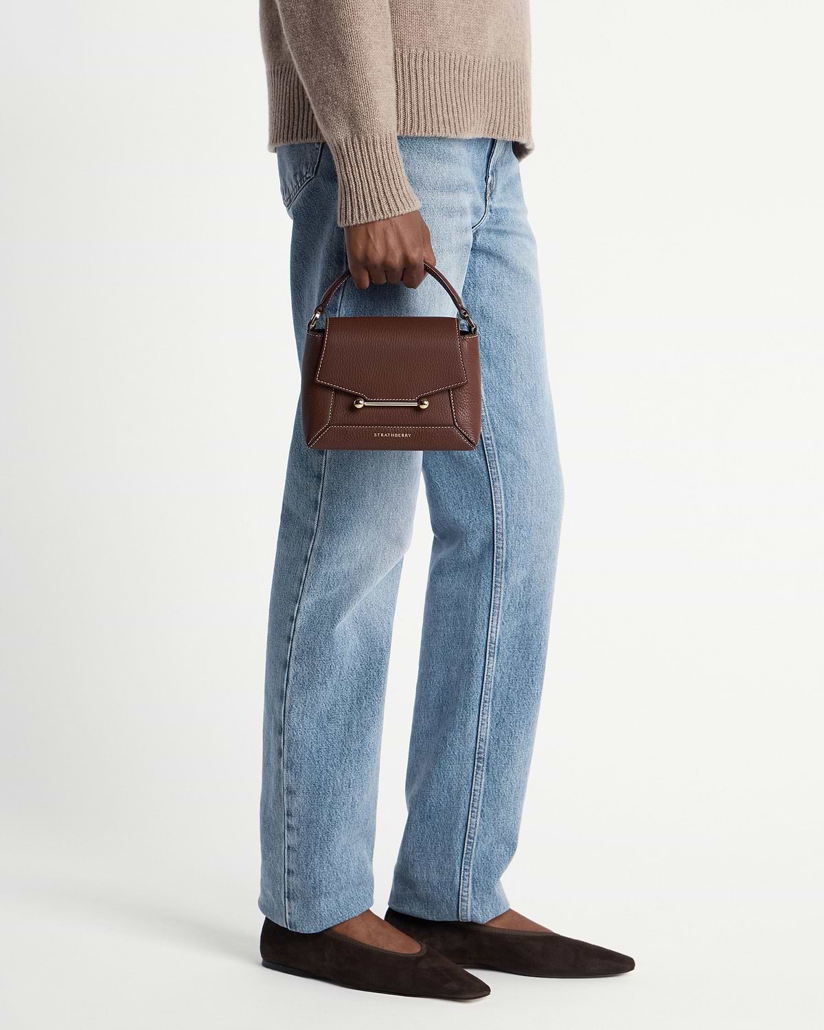 Strathberry Mosaic Nano chocolate leather top-handle bag with vanilla stitching, handheld.