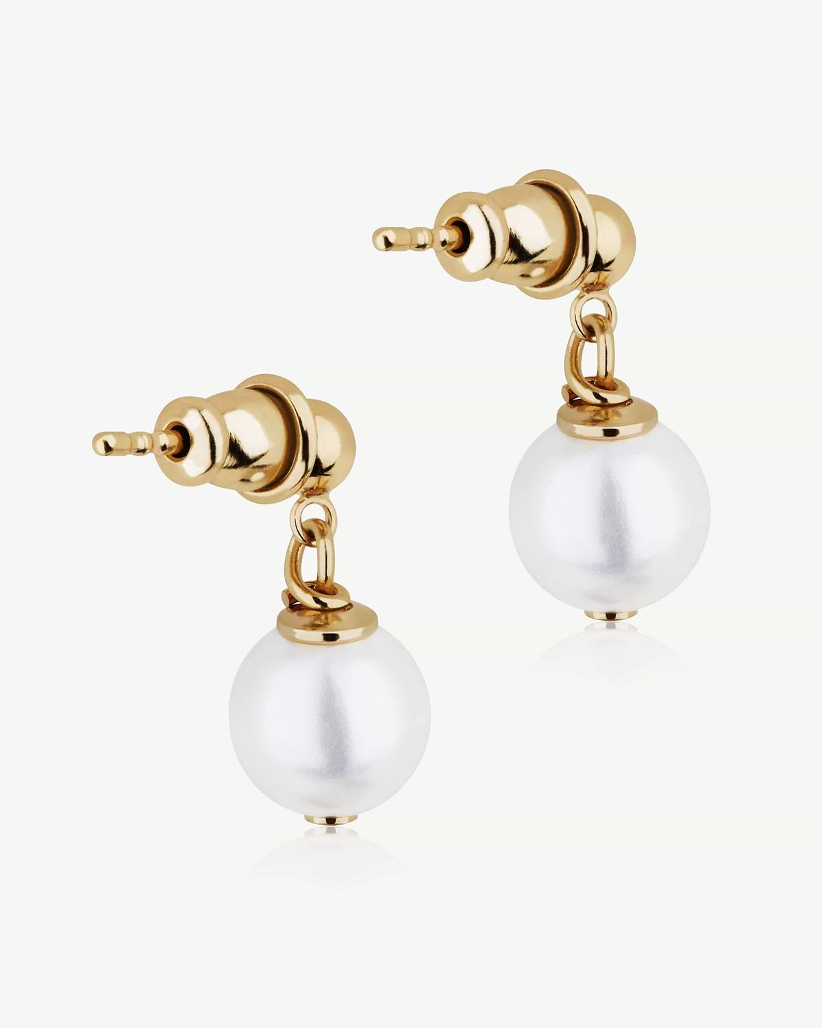 Two gold-gilded earring posts with hanging white pearl beads on white background.