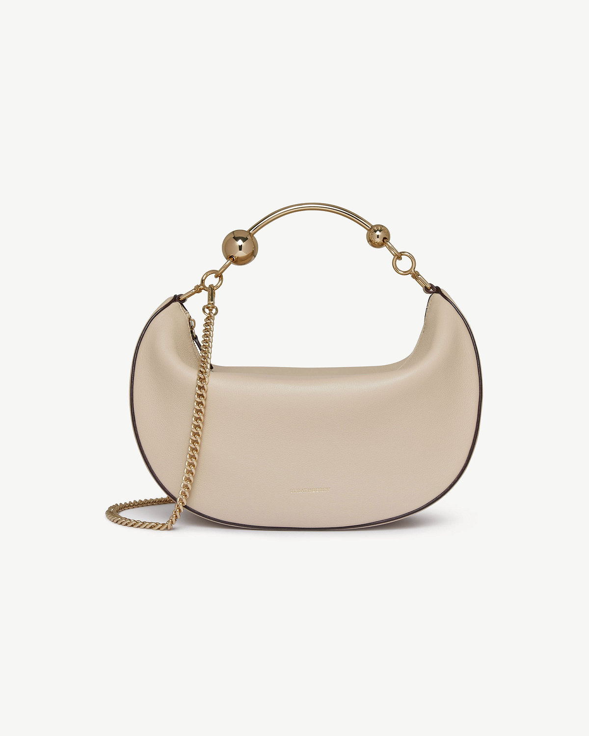 Oat crescent moon shoulder bag with gold metal handle and chain strap.