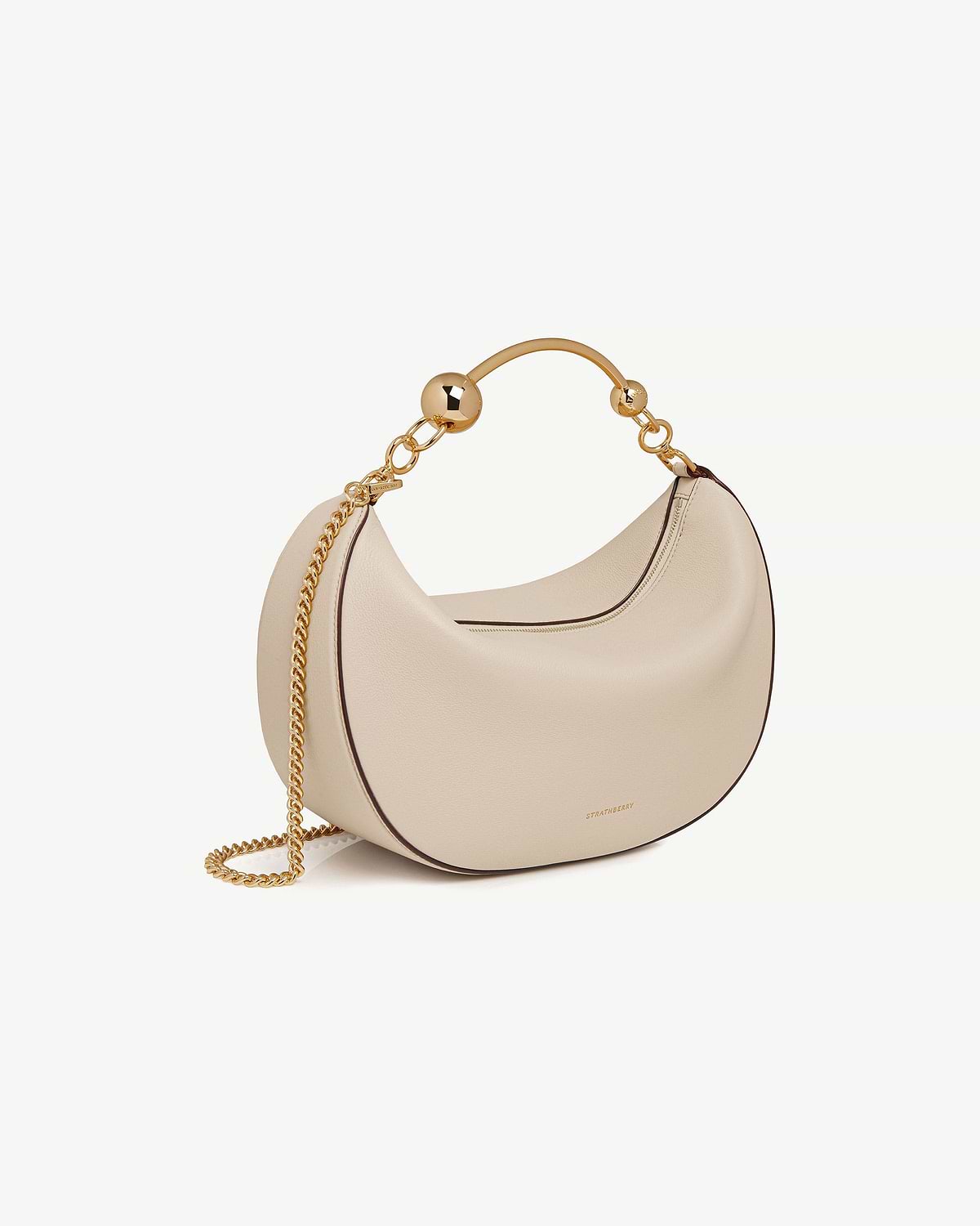 Strathberry Crescent Moon bag in oat with gold chain and ball handle.