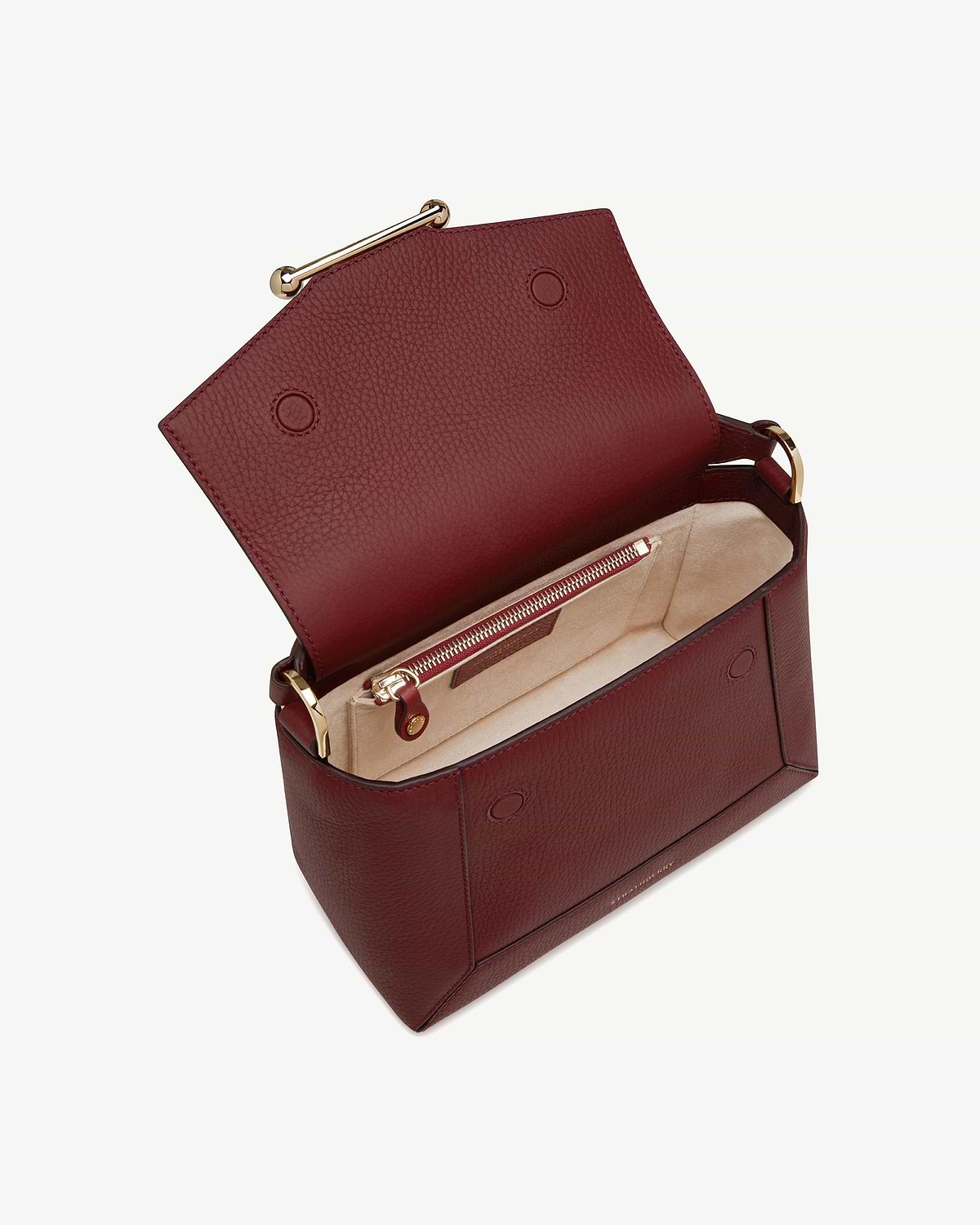 Oxblood leather mosaic bag open showing beige suede interior and gold hardware.