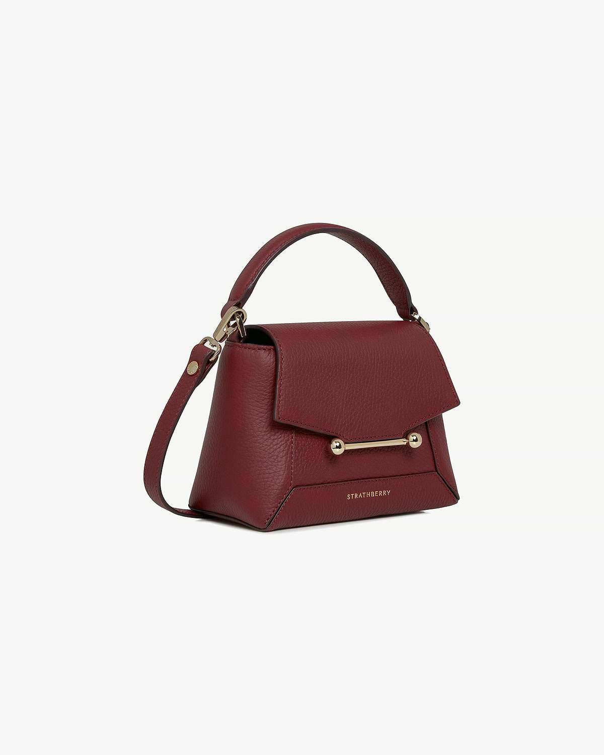 Strathberry Mosaic Nano oxblood leather bag with top handle and gold bar.