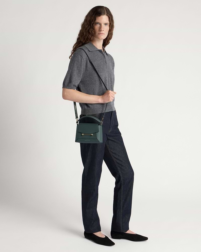 Model wearing grey top and jeans with bottle green Mosaic Nano crossbody bag.