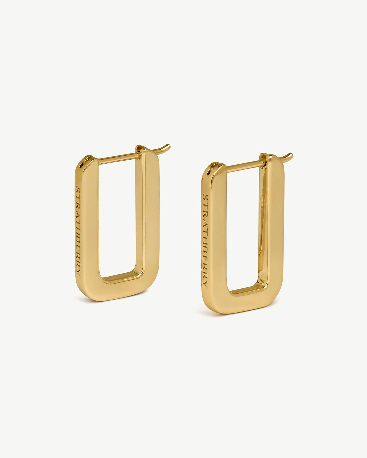 Strathberry rectangular hoop earrings, 22 carat gold gilded, pair on white background