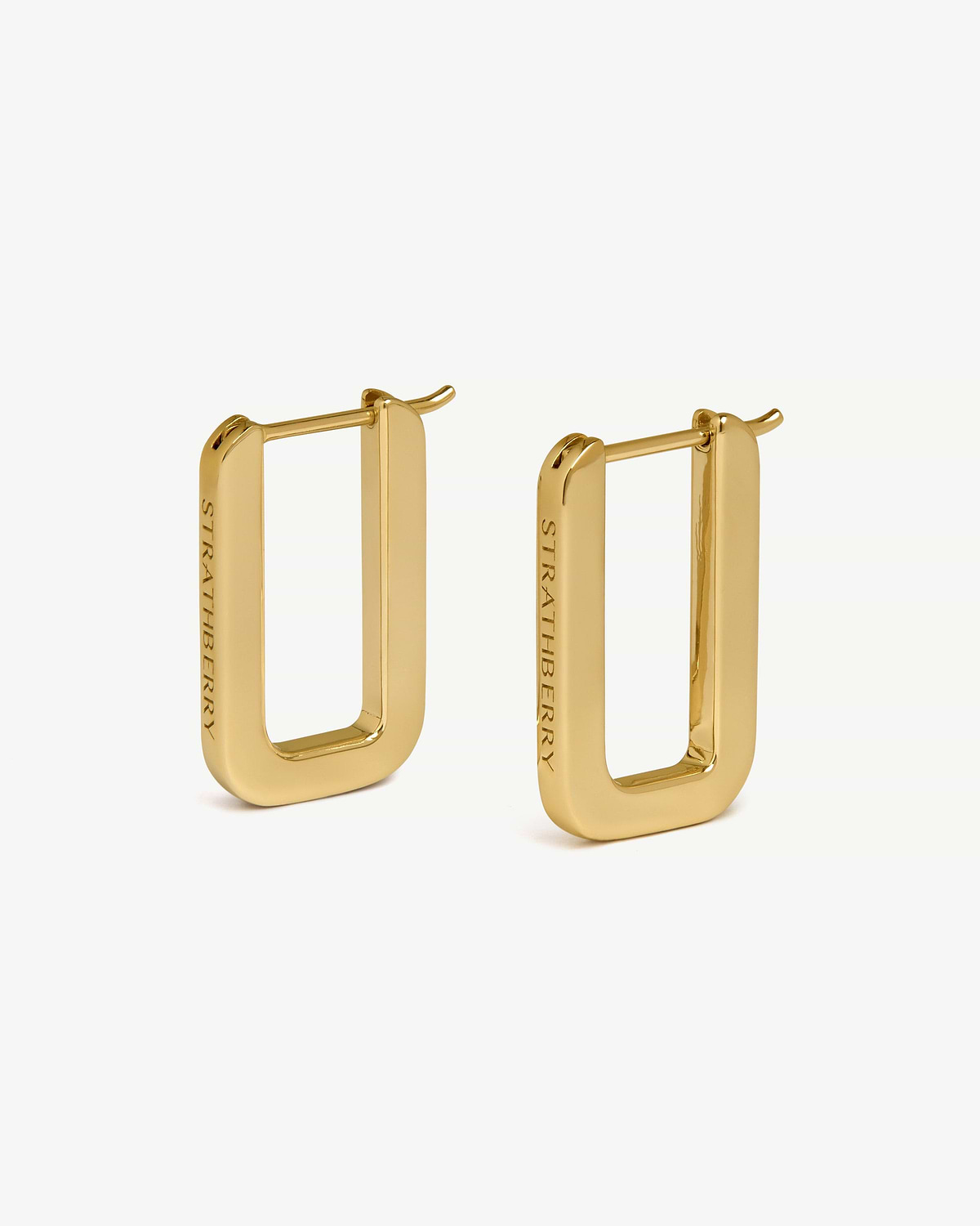 Strathberry rectangular hoop earrings, 22 carat gold gilded, pair on white background
