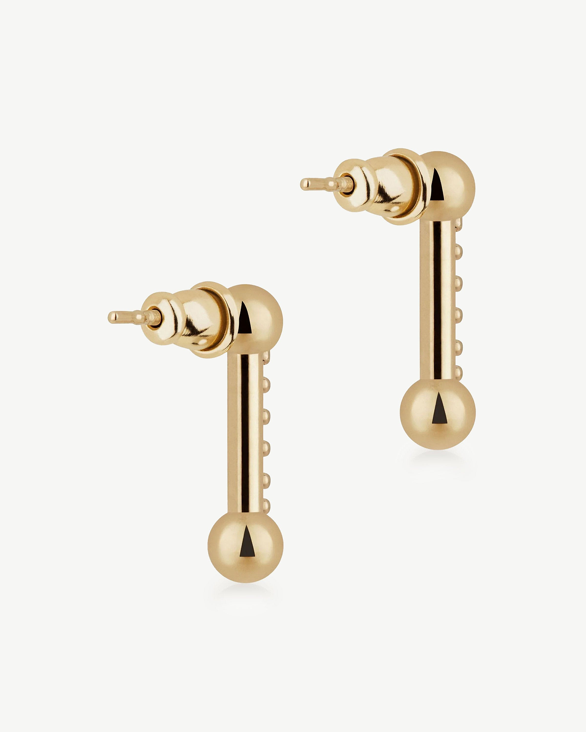 Pair of gold bar drop earrings with spherical ends on a white background.