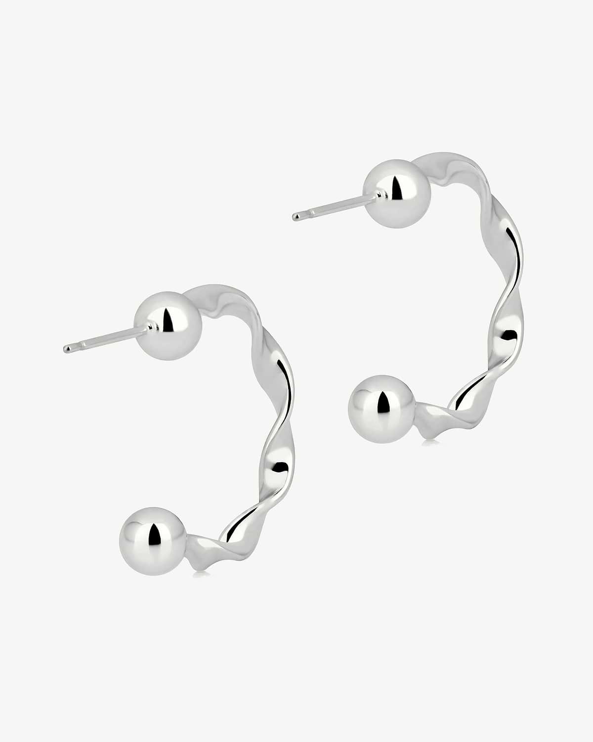 Pair of sterling silver crescent twisted hoop earrings with polished ball ends.