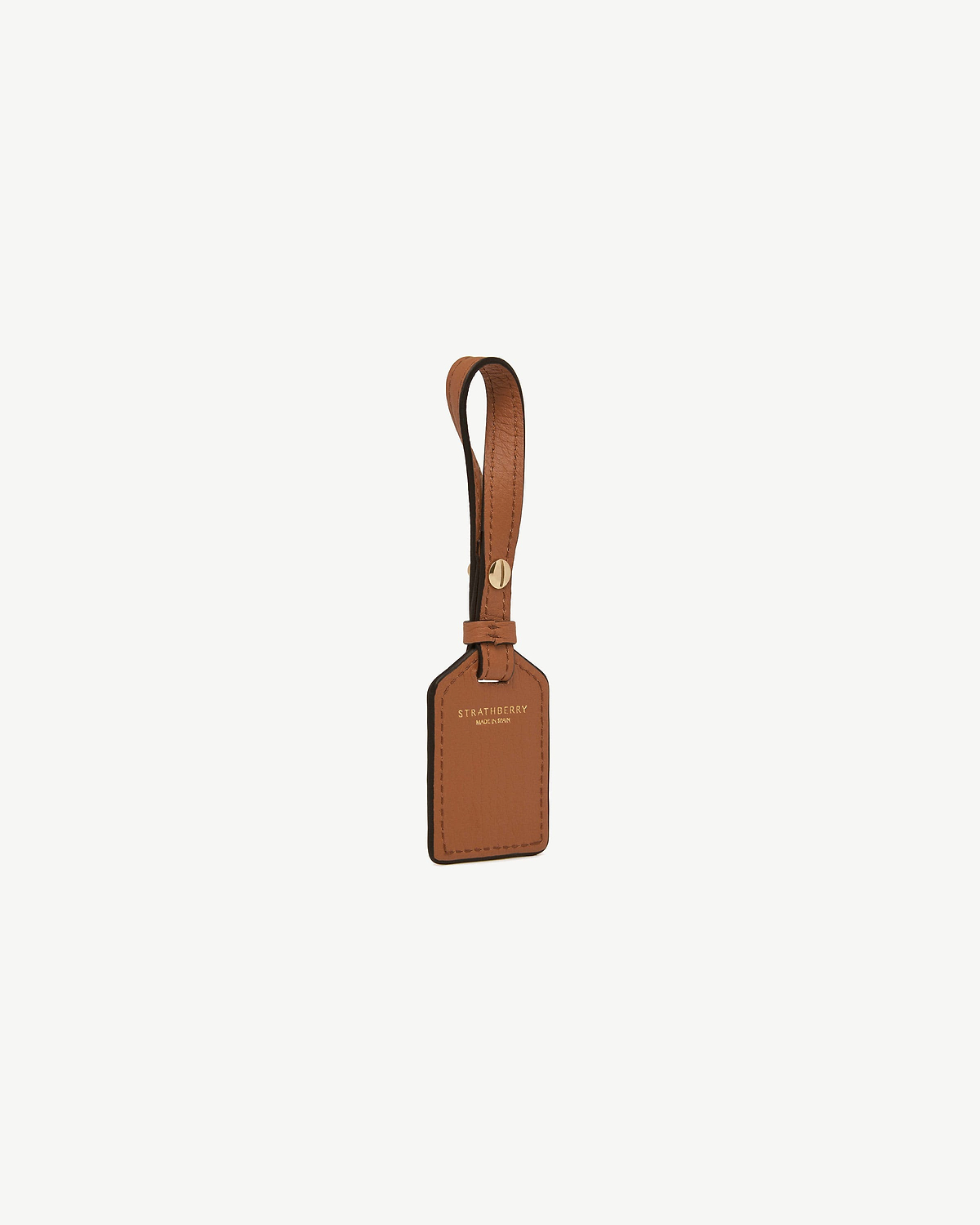 Tan leather luggage tag with strap and gold Strathberry logo