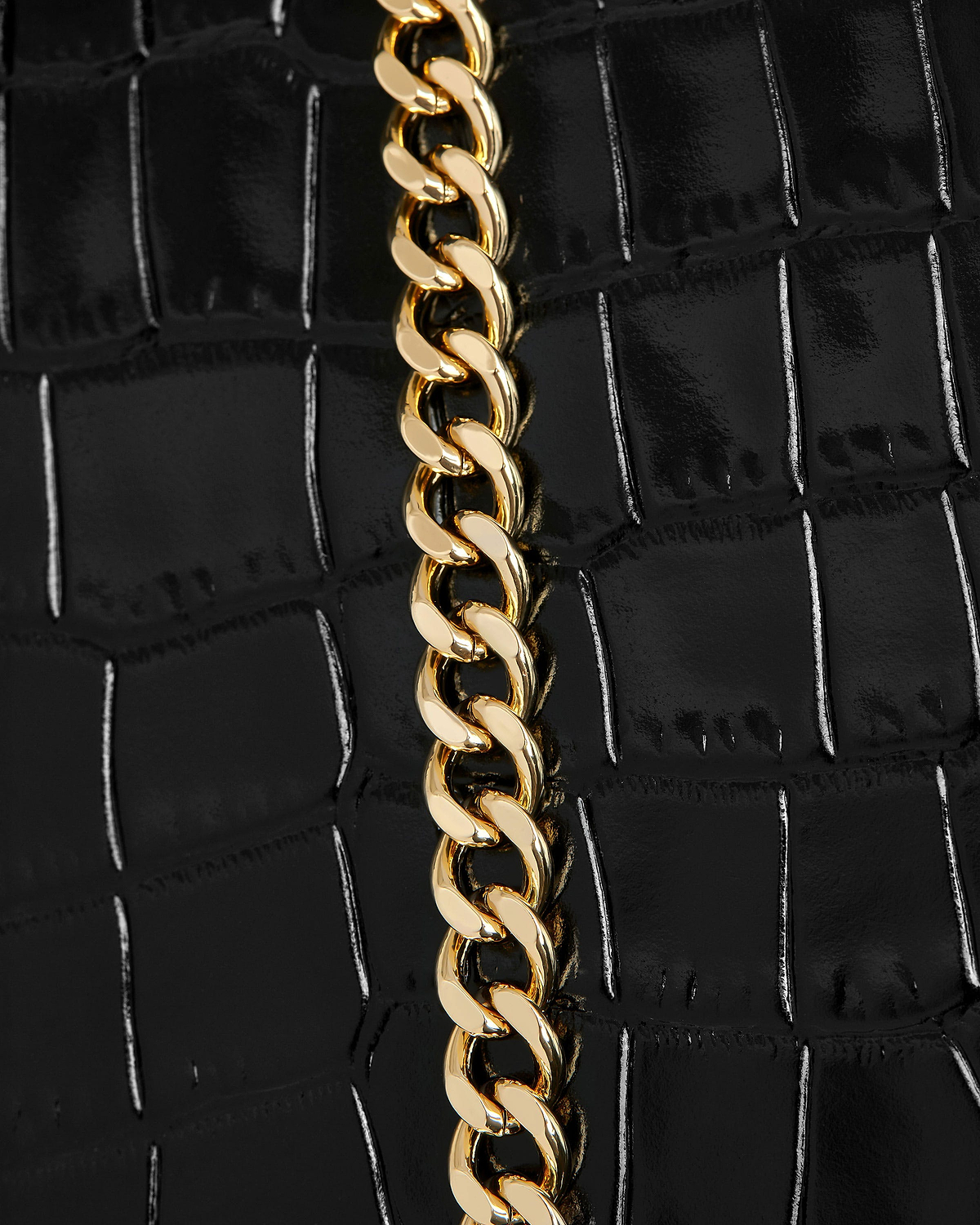 Mini tote in black croc pattern with a vertical gold chain strap.