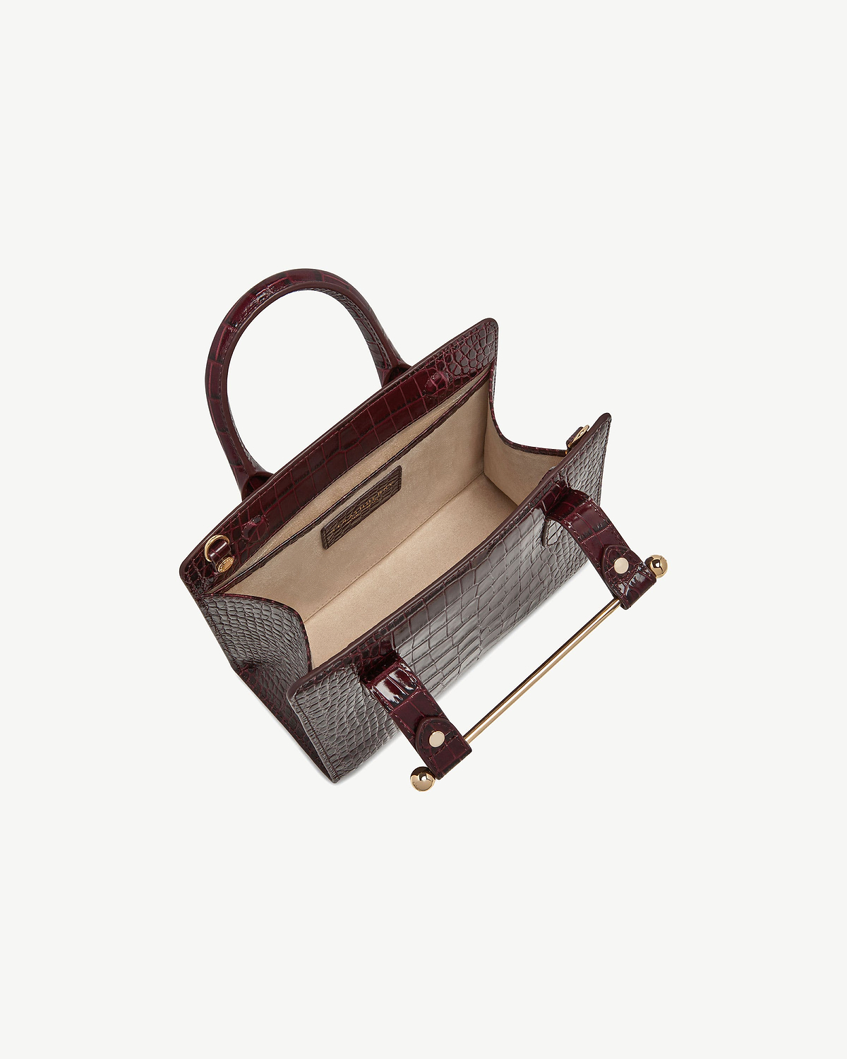 Burgundy croc mini tote with open top showing beige interior and gold bar hardware
