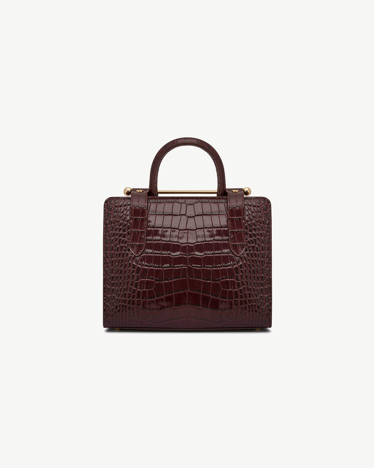 Mini tote in croc-embossed leather with a top handle and gold bar detail.