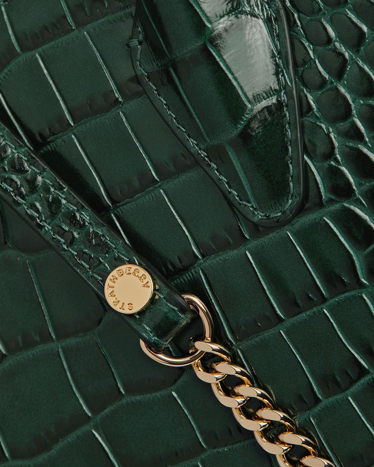 Green crocodile-embossed mini tote with gold chain and Strathberry stud.