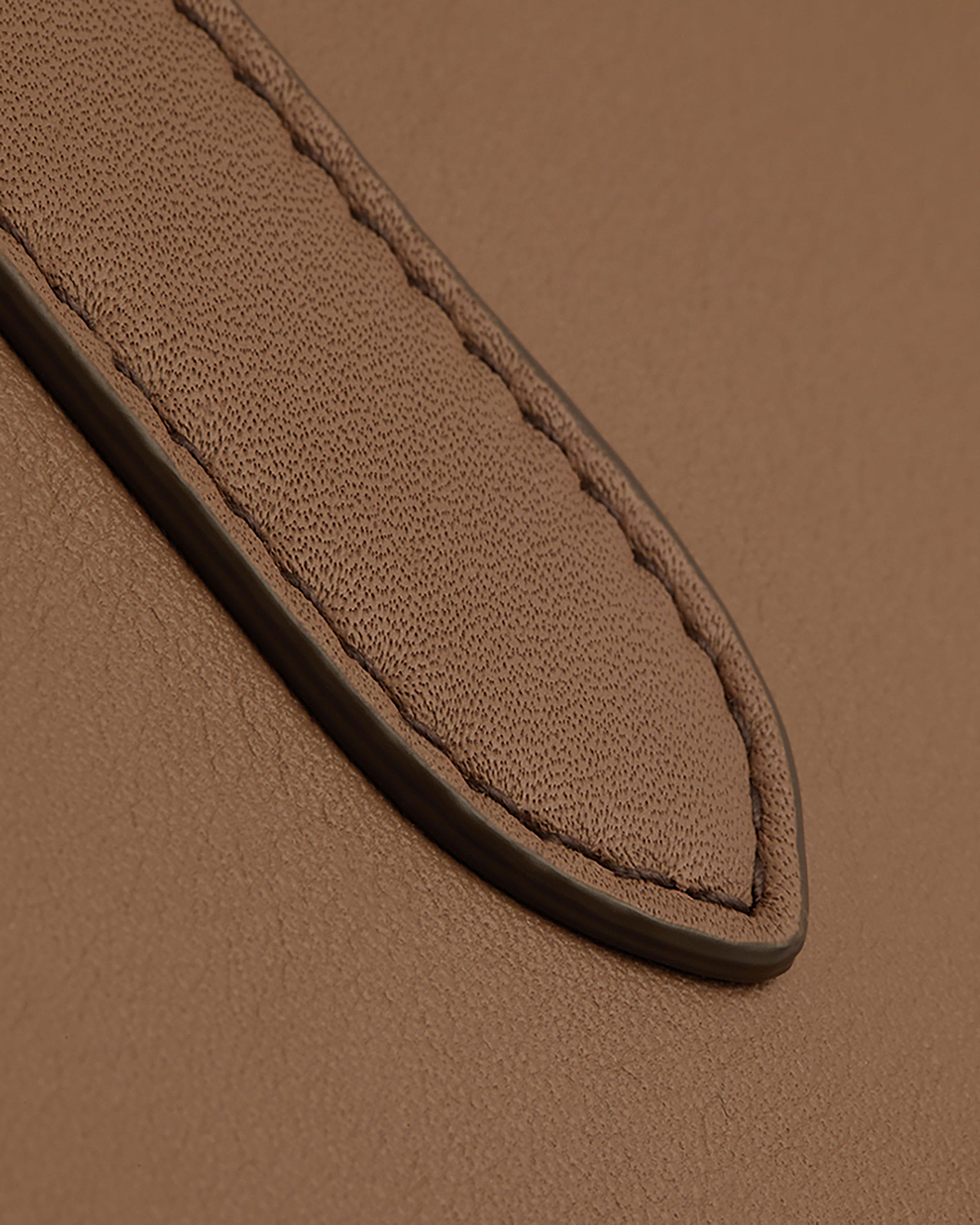 Clay mini tote leather strap with visible pebbled texture and stitched piped edge
