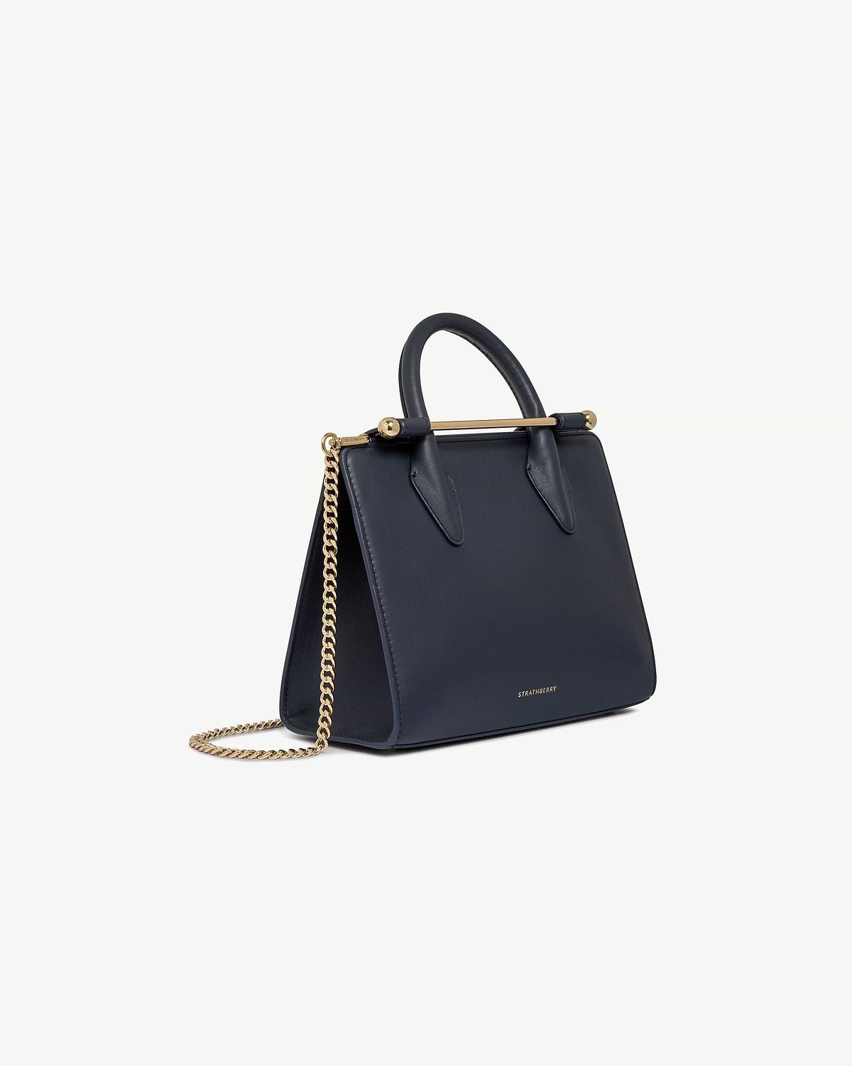 Marine blue Strathberry mini tote with top handle, gold bar and chain strap.