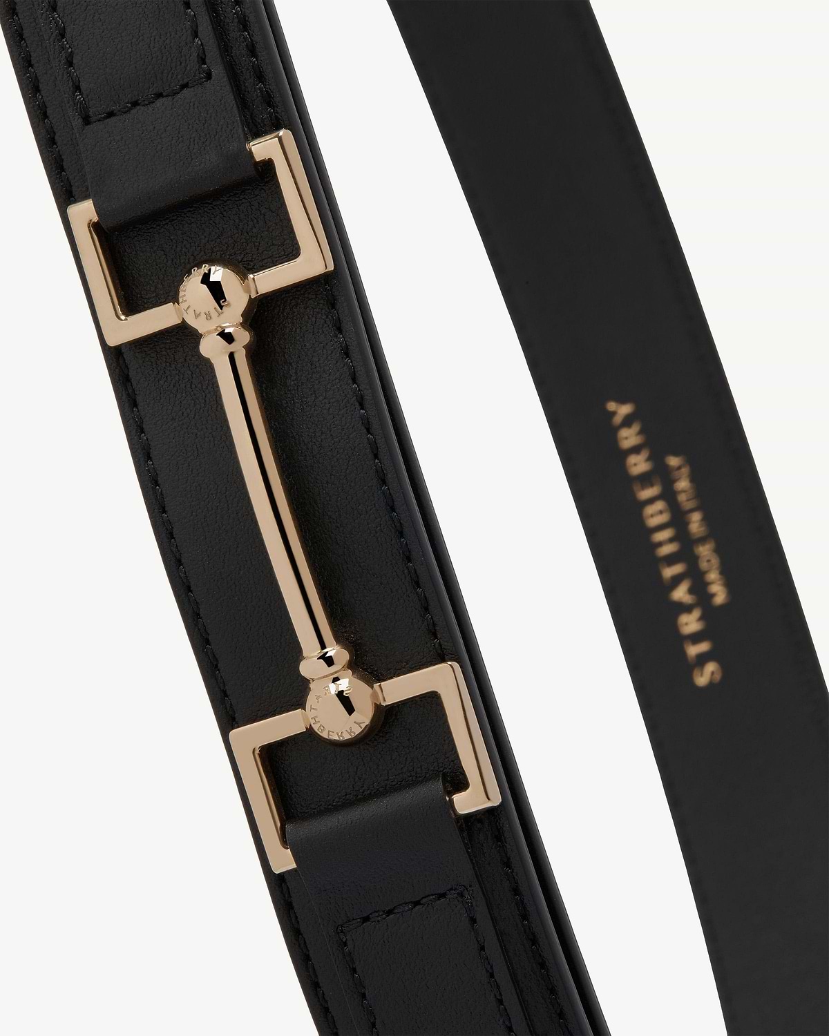 Black leather Stockbridge belt with gold bar hardware and Strathberry stamp.