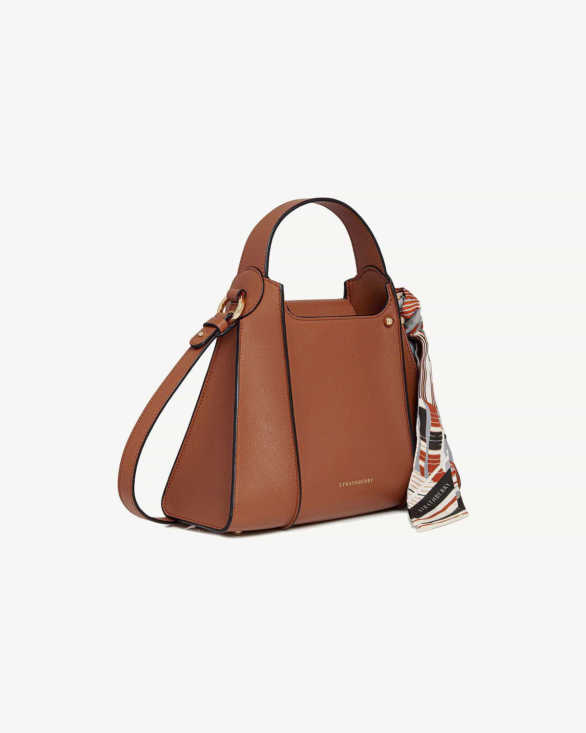 Tan Arkshell Strathberry handbag with top handle, shoulder strap, patterned scarf and gold hardware.