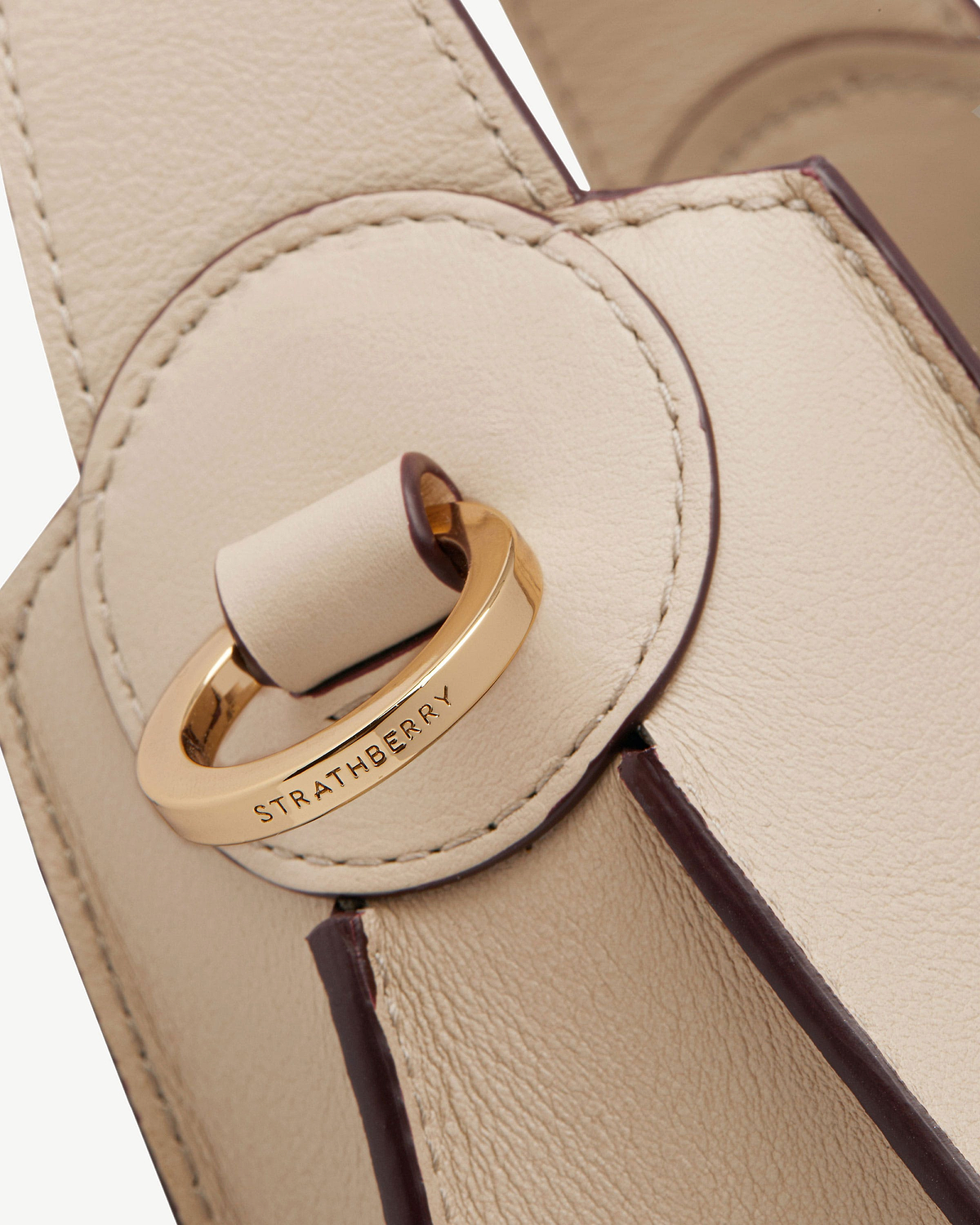 Strathberry Arkshell oat leather bag with gold ring clasp and stitched edges