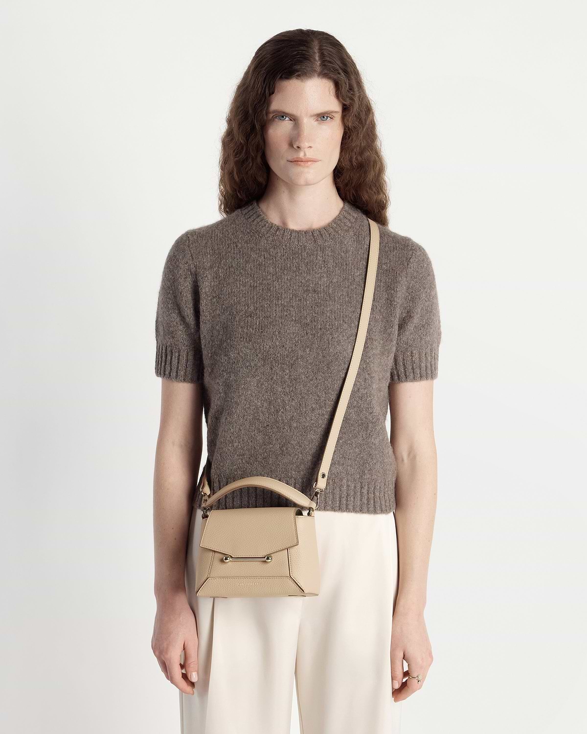 Model wearing sand Strathberry Mosaic Nano bag with long strap across body