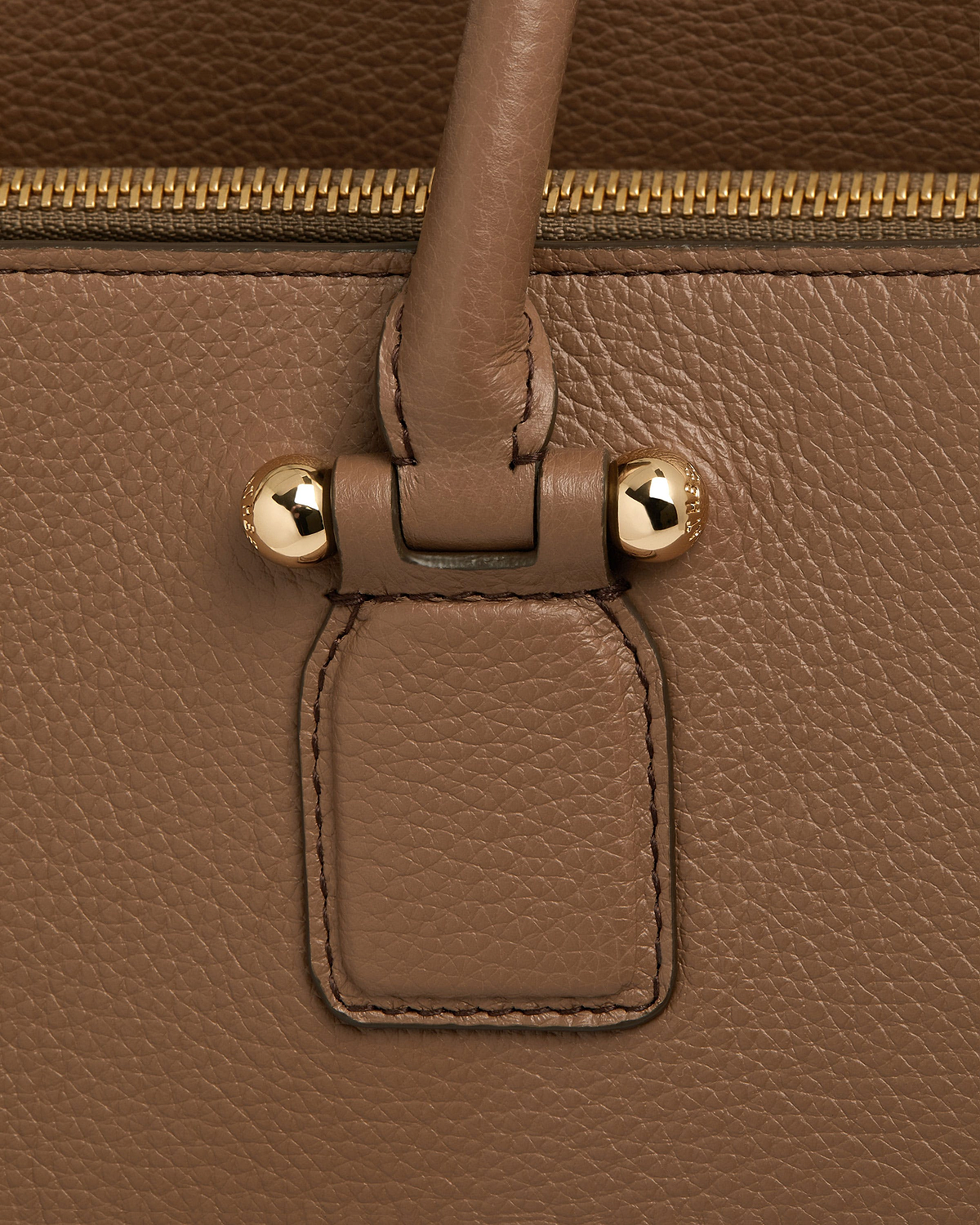 Clay pebbled leather bag handle attachment with gold studs and zip