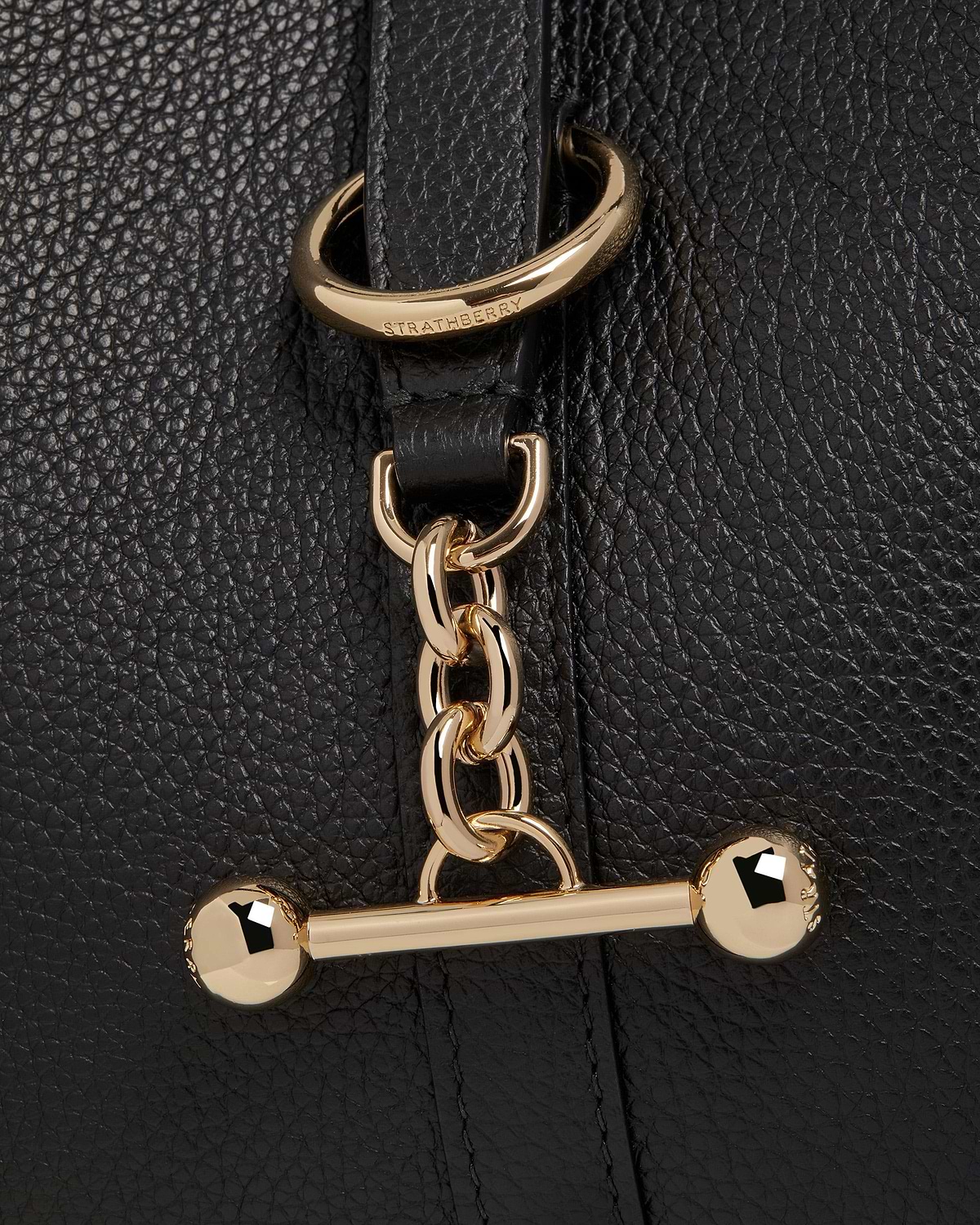 Strathberry Kite Hobo black pebbled leather showing gold chain and bar hardware