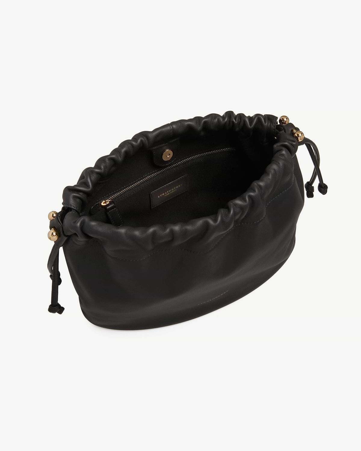 Black Strathberry Charlotte Midi drawstring bag, open top showing interior zip pocket.