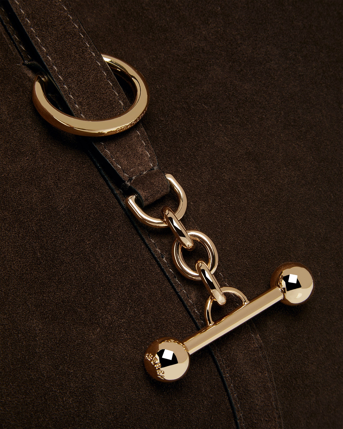 Chocolate suede strap with gold rings, chain links and toggle hardware.