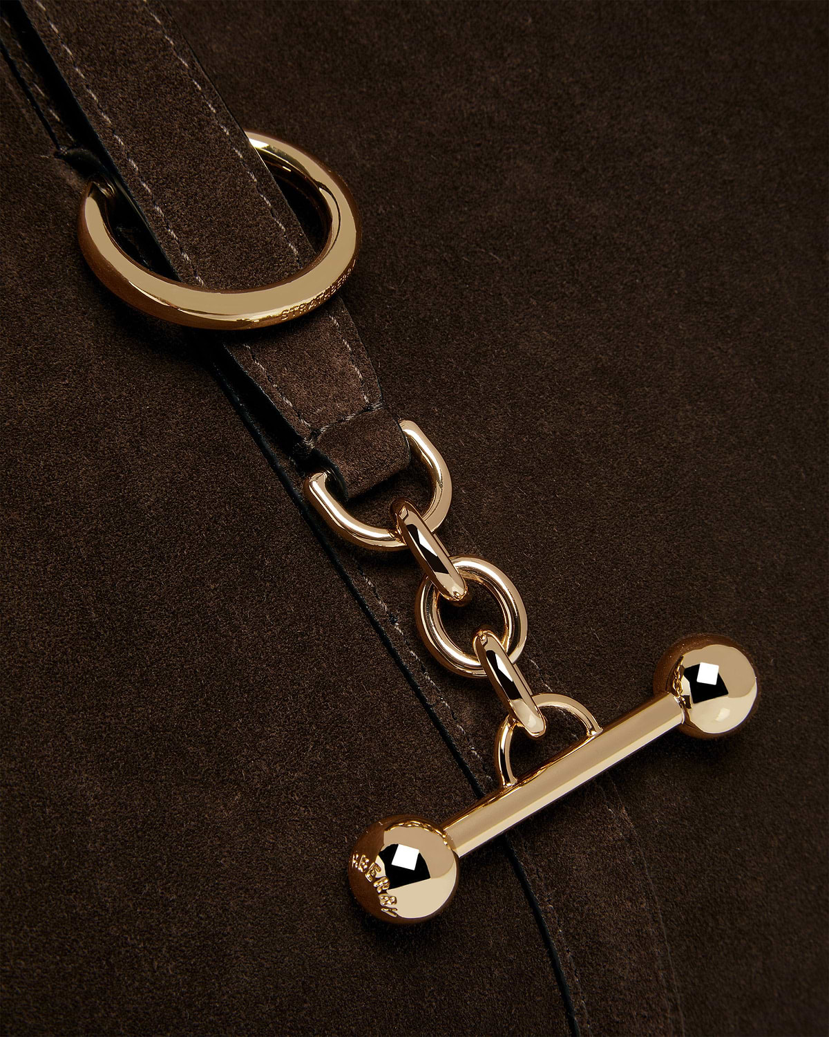 Chocolate suede strap with gold rings, chain links and toggle hardware.