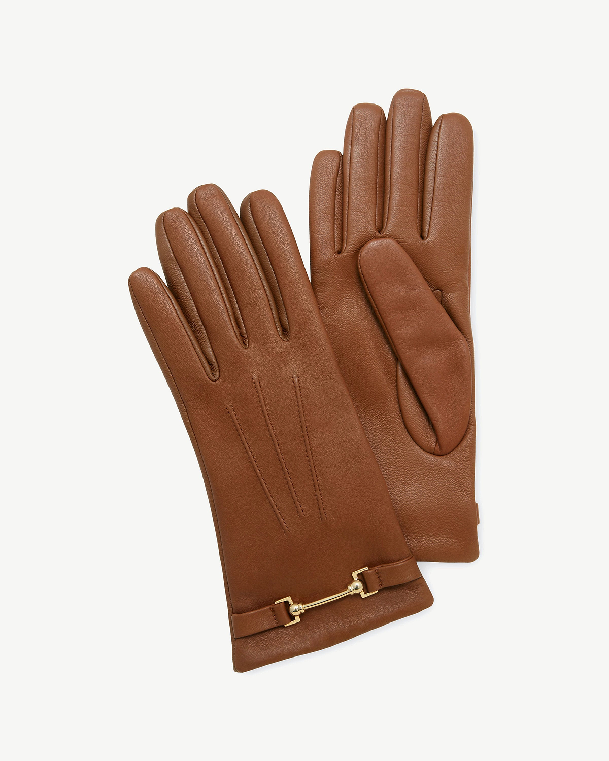 Pair of tan leather gloves with three stitched lines and gold metal bar detail.