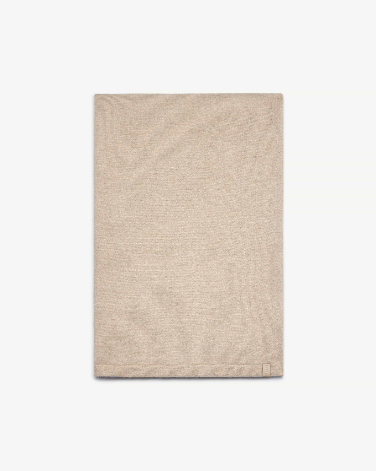 Oat cashmere travel wrap folded neatly on a white studio background.