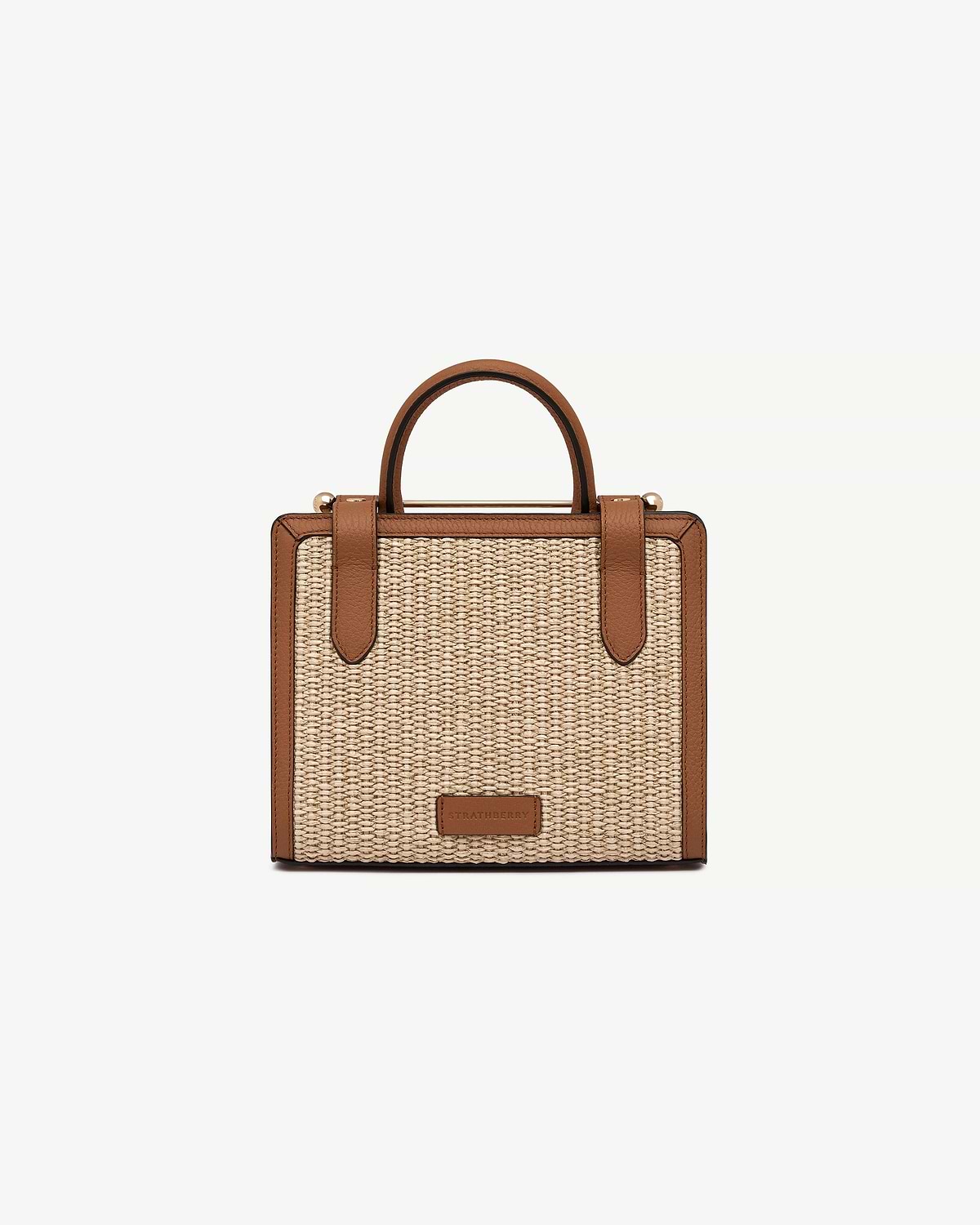 Mini tote in tan leather trim with natural raffia body and Strathberry logo.