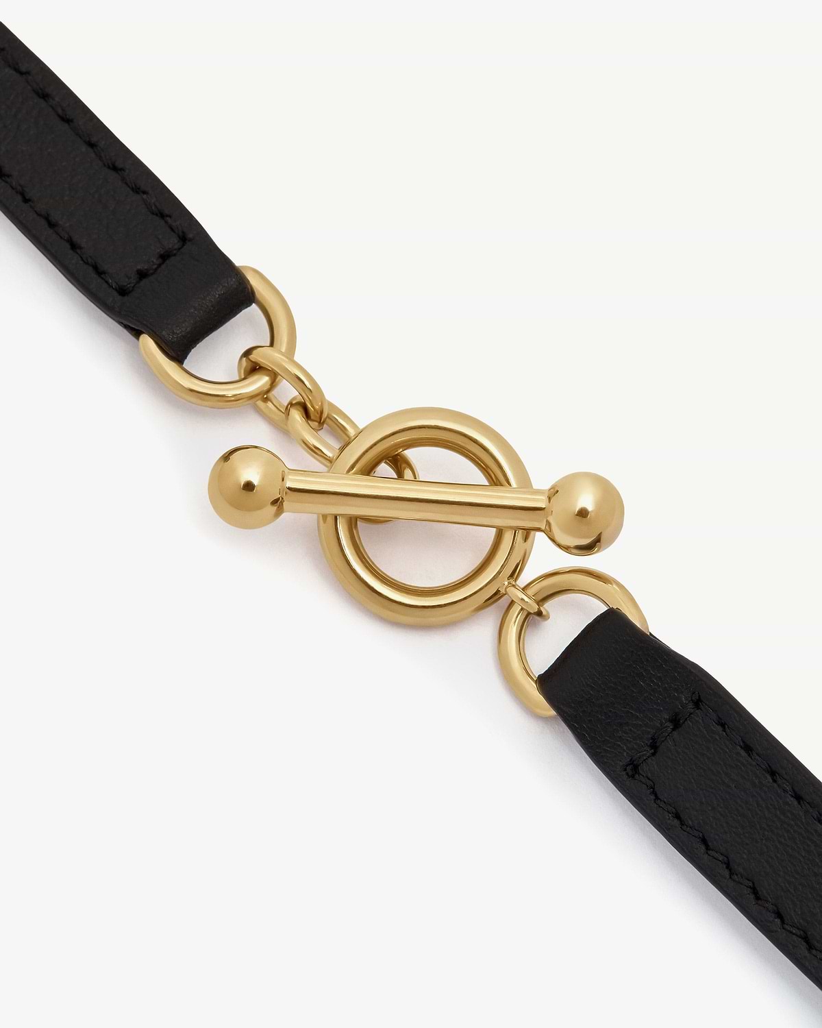 Black leather bracelet strap with gold toggle clasp and round links