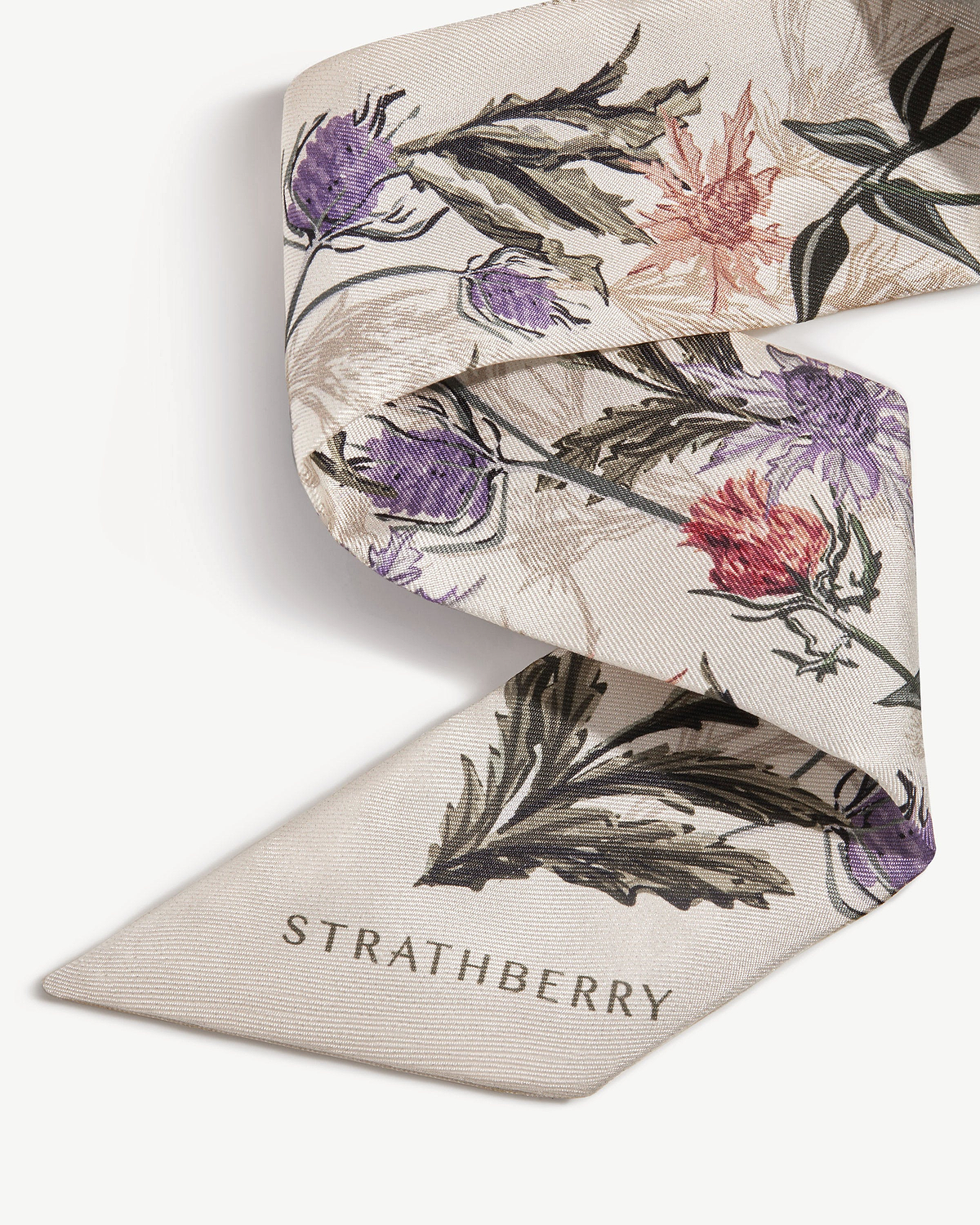 Vanilla silk skinny scarf with forest green thistle print and Strathberry logo.