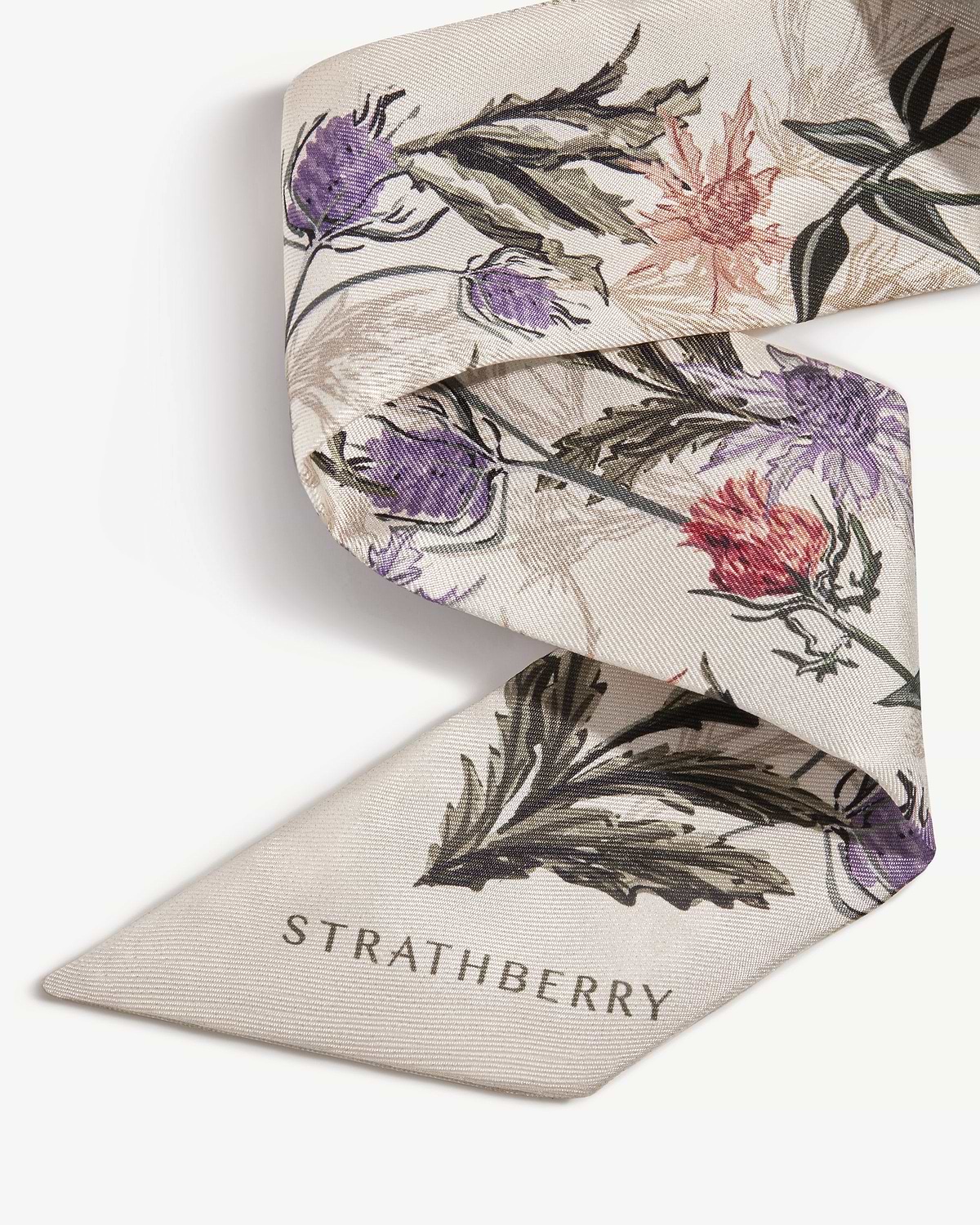 Vanilla silk skinny scarf with forest green thistle print and Strathberry logo.