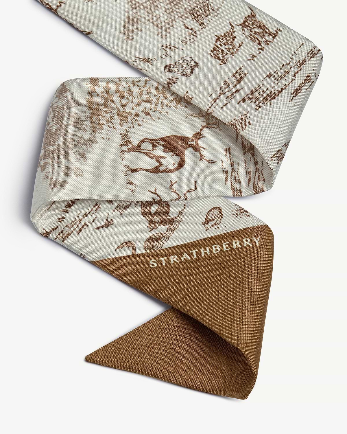Tan and vanilla silk skinny scarf with animal wallpaper print and Strathberry logo.
